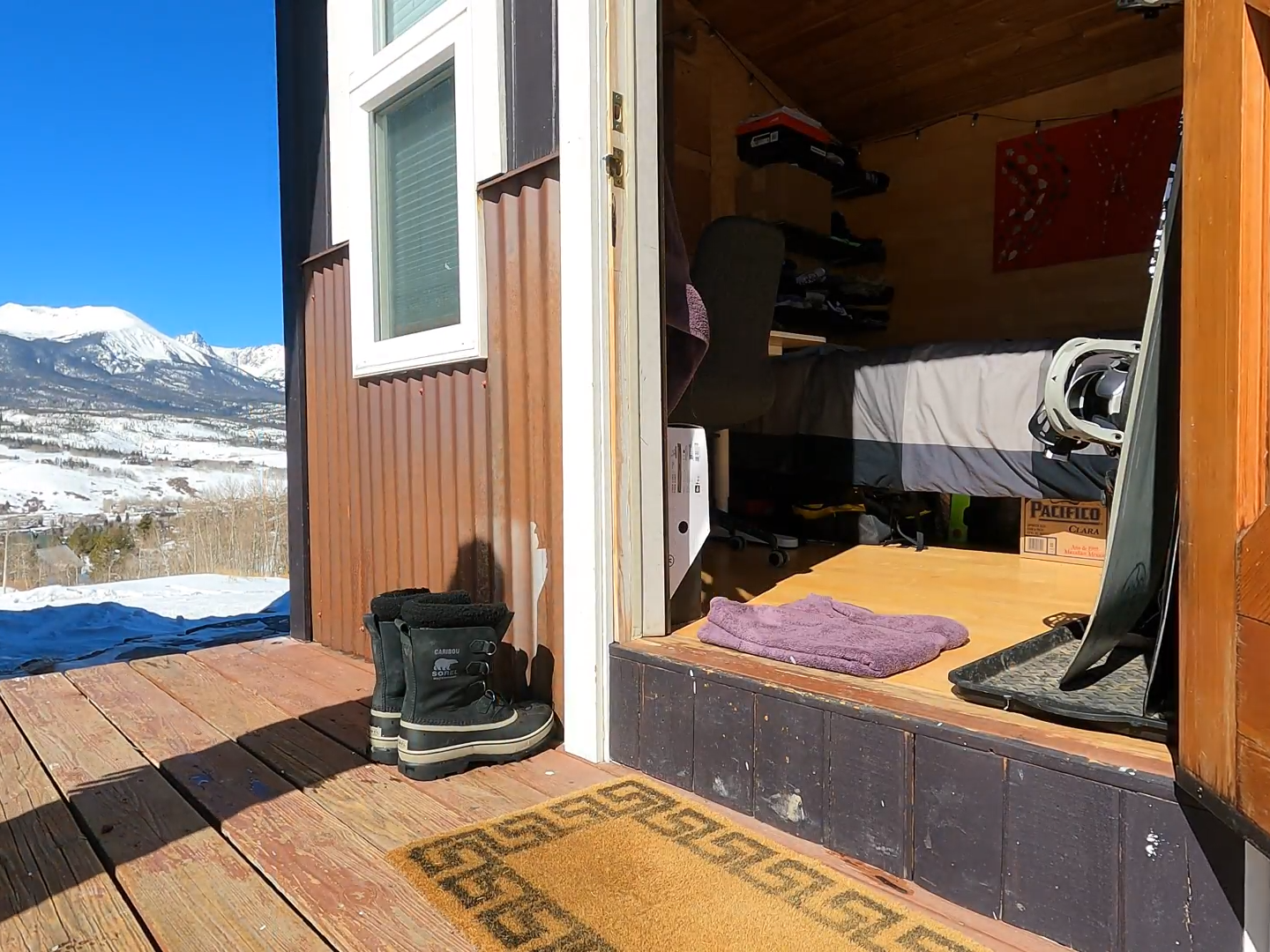 Door open to tiny home with mountains in background Keenan Laurence