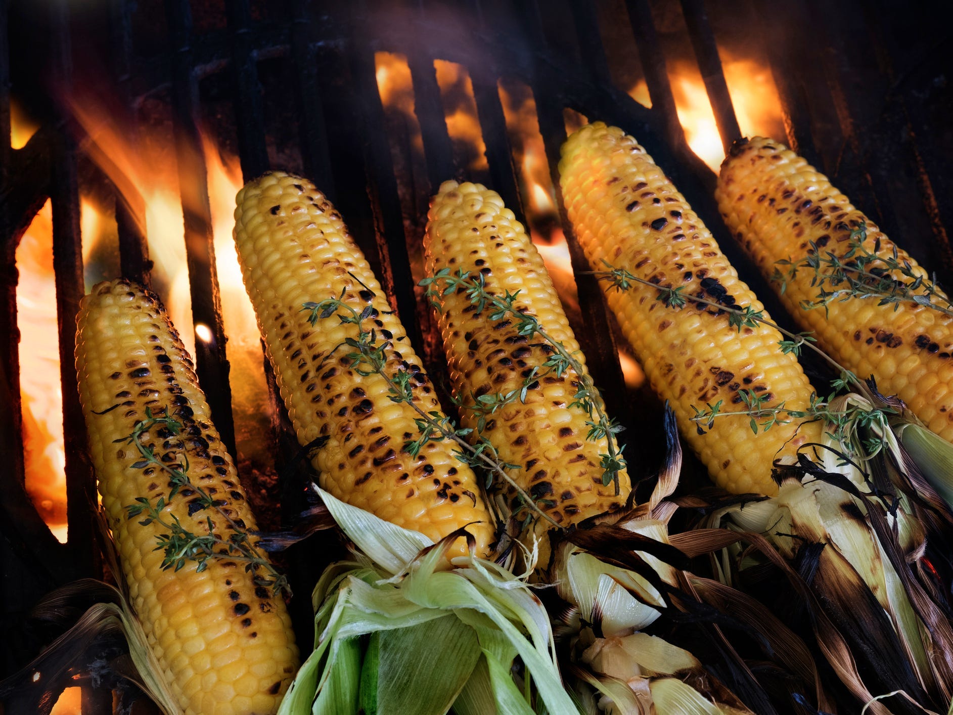 Corn on the grill topped with thyme