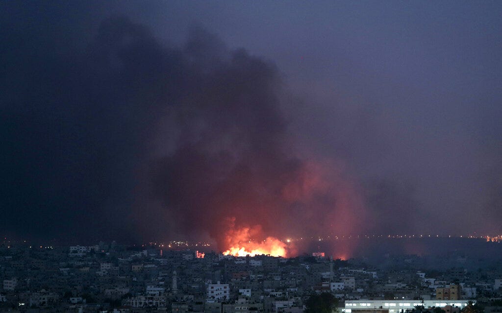Smoke rises in the air as flame spread across buildings after Israeli strikes in Shijaiyah neighbourhood in Gaza City, Sunday, July 20, 2014
