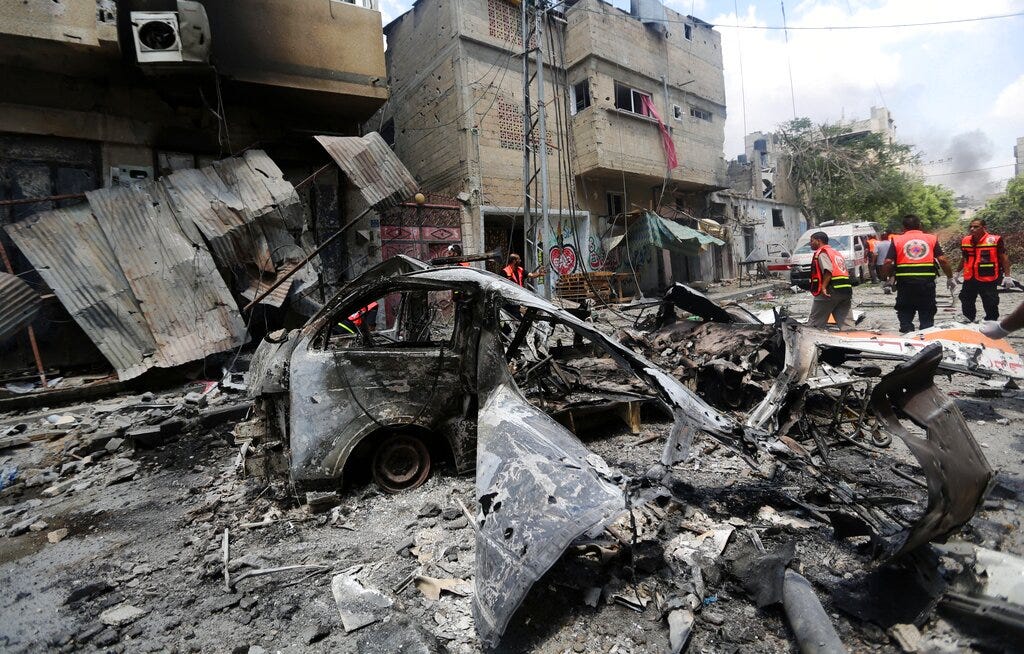 Palestinians medic inspect the damage in Gaza City's Shijaiyah neighborhood that came under fire as Israel widened its ground offensive against Hamas in the northern Gaza Strip on Sunday, July 20, 2014