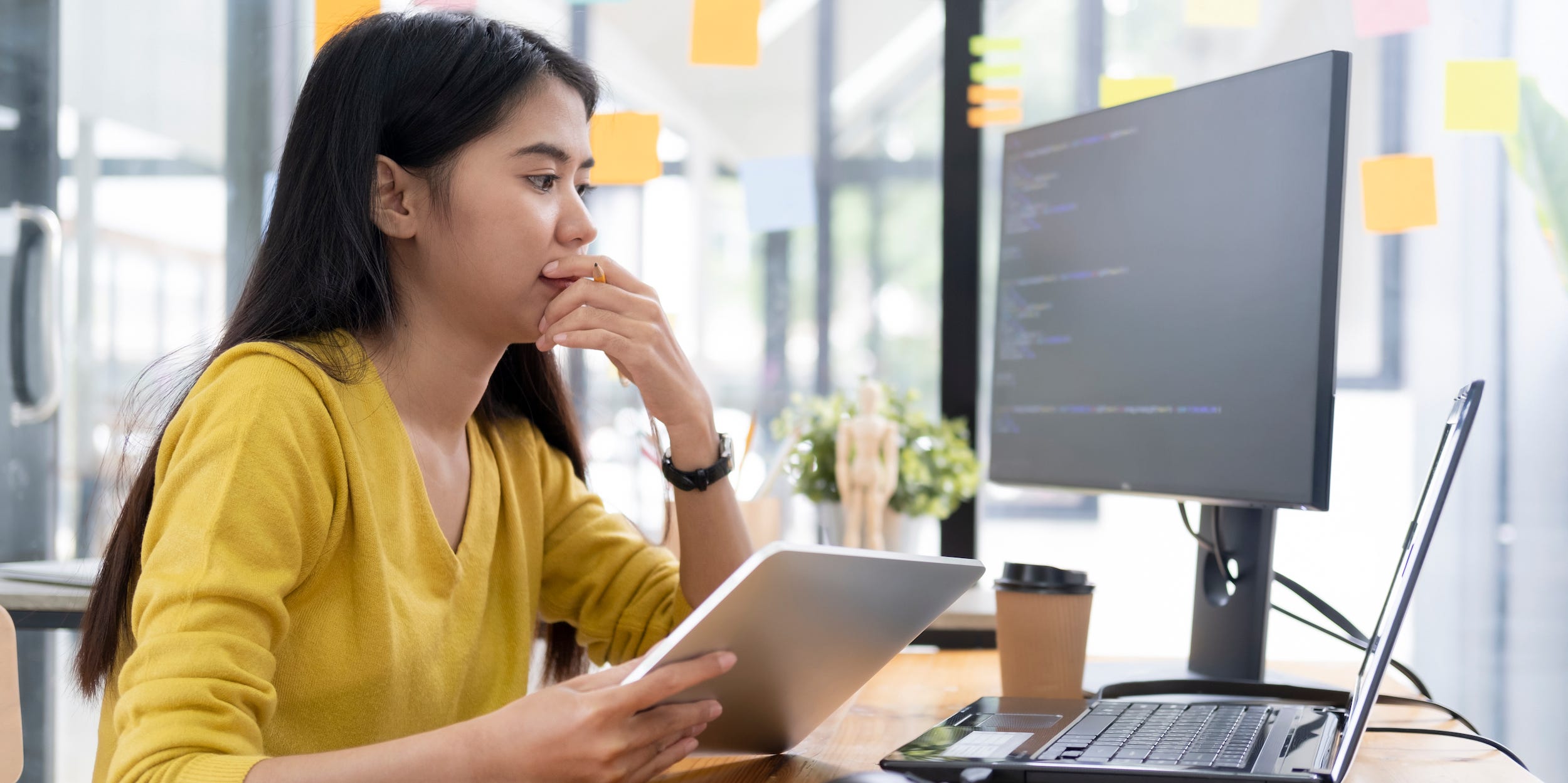 software developer analyzing data on laptop tablet desktop