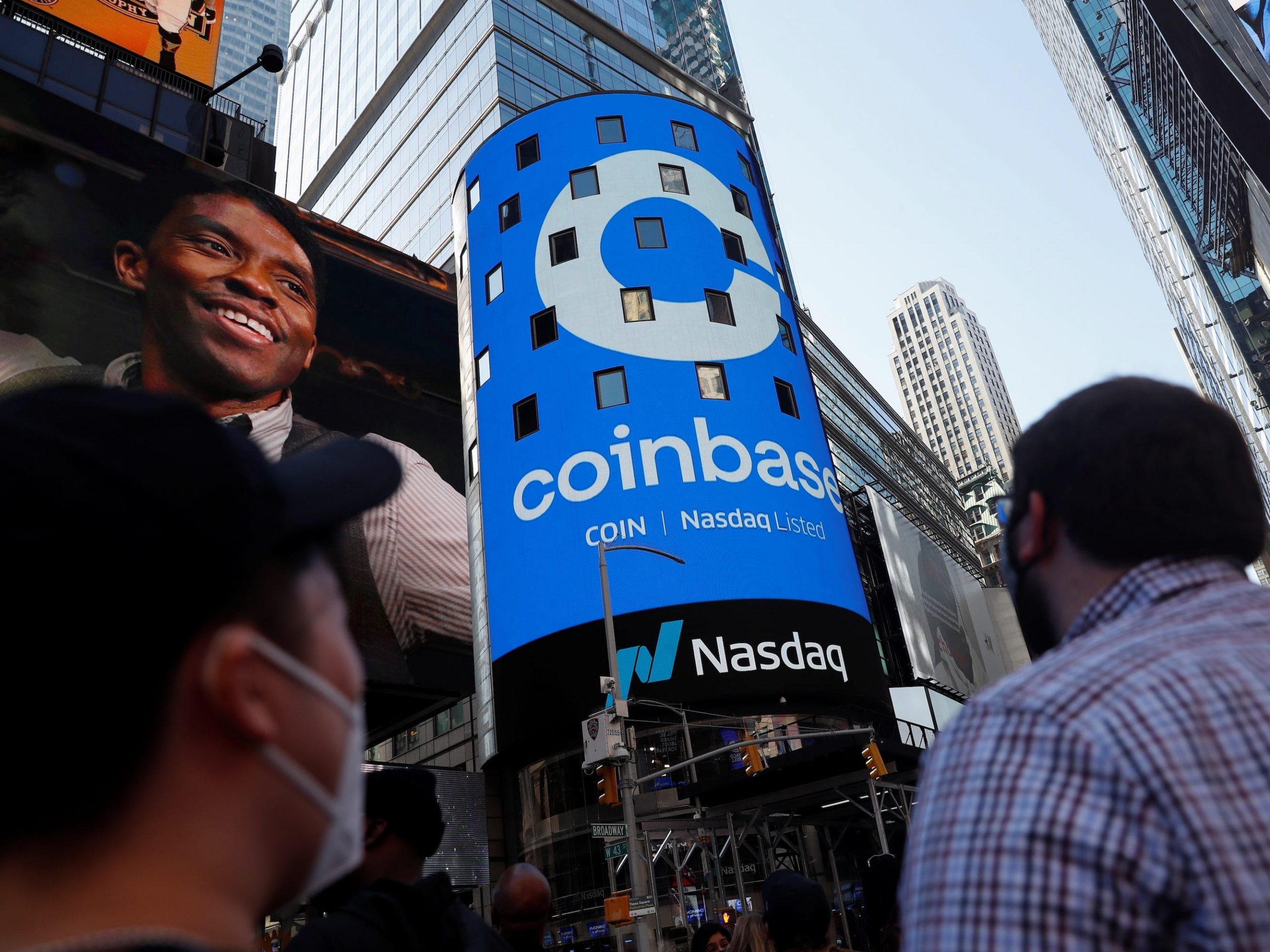 People watch from Times Square on the day Coinbase made its public trading debut on the Nasdaq in April.