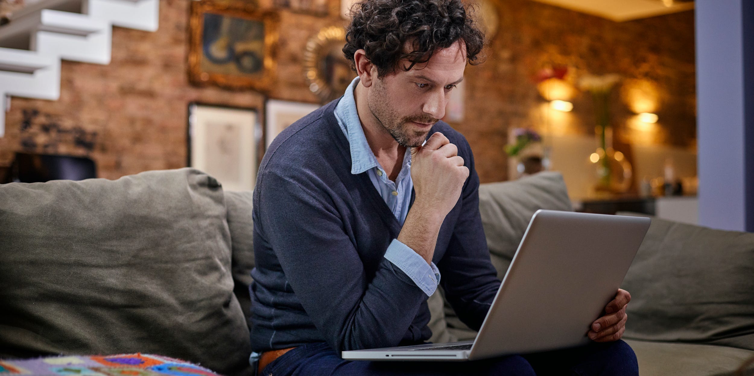 man using laptop computer at home