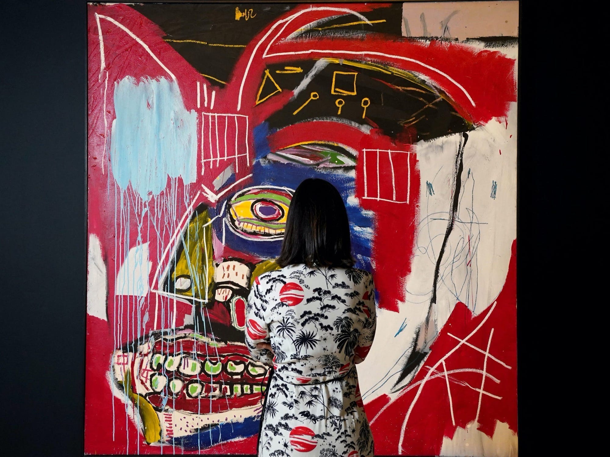 A woman looks at Jean-Michel Basquiat's "In This Case" during a press preview on May 3, 2021 for a Christie's sale New York.