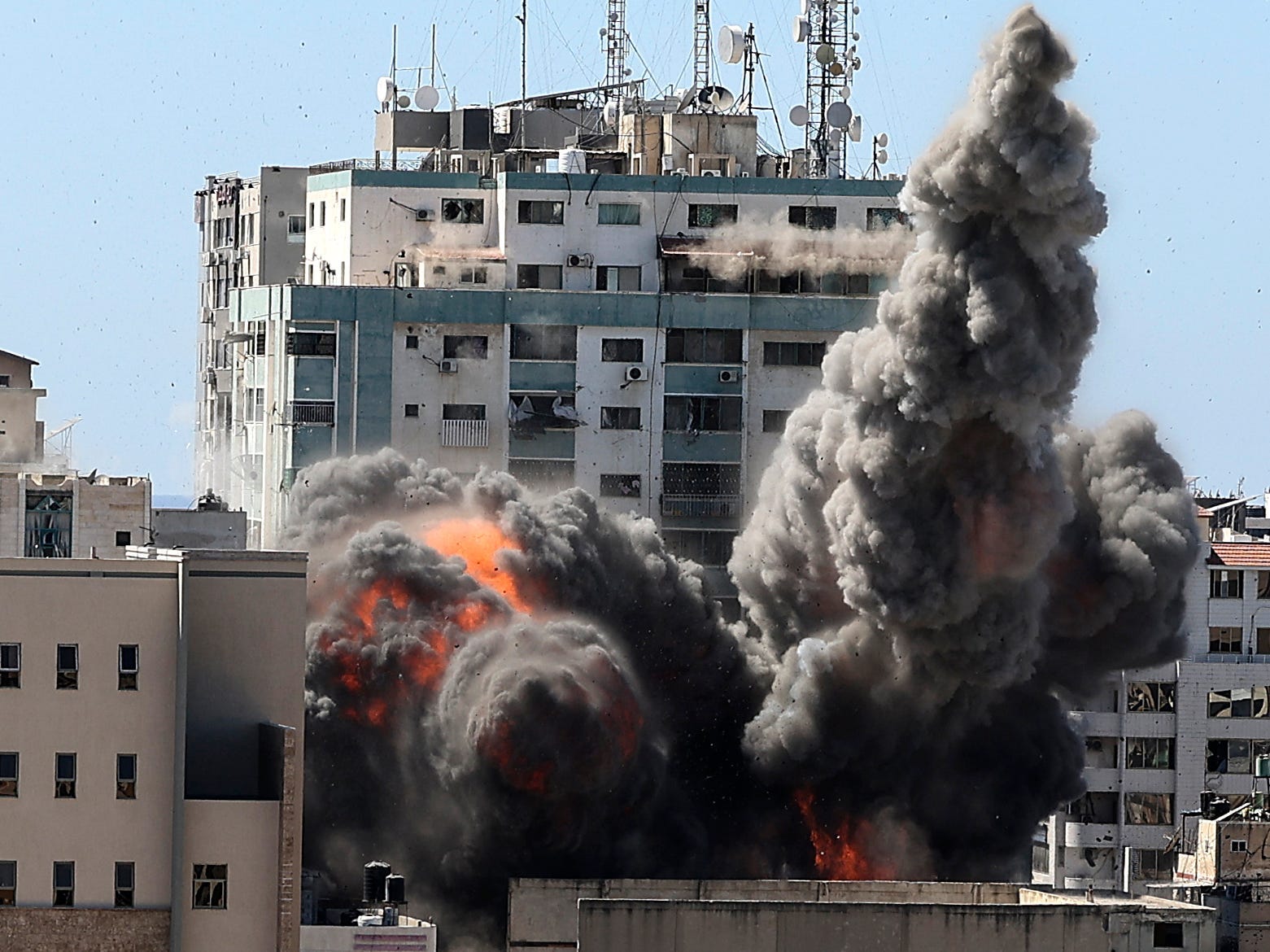 Smoke billows from a media building in Gaza that was struck by Israeli airstrikes