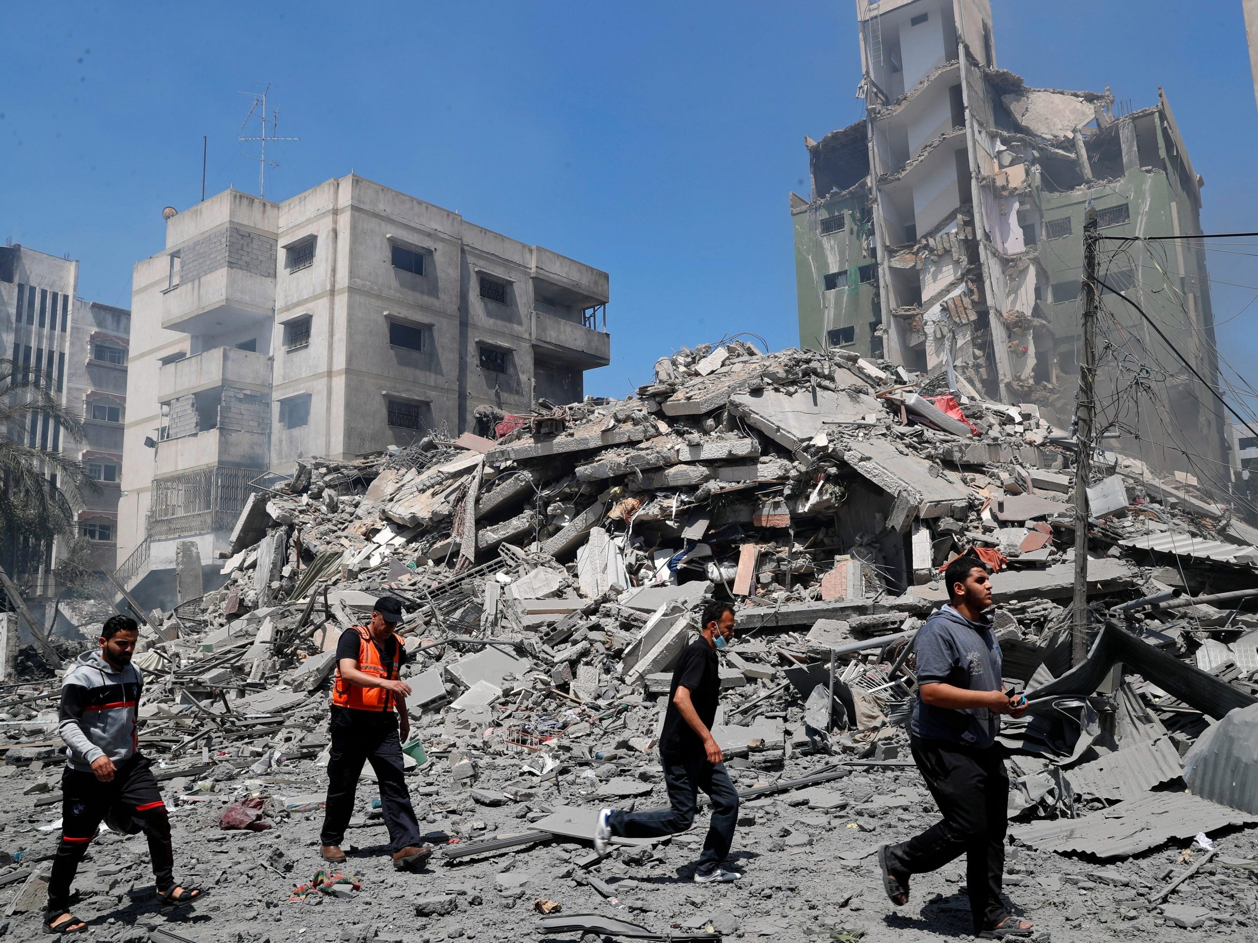 People inspect the rubble of a building in Gaza that was destroyed by an Israeli airstrike
