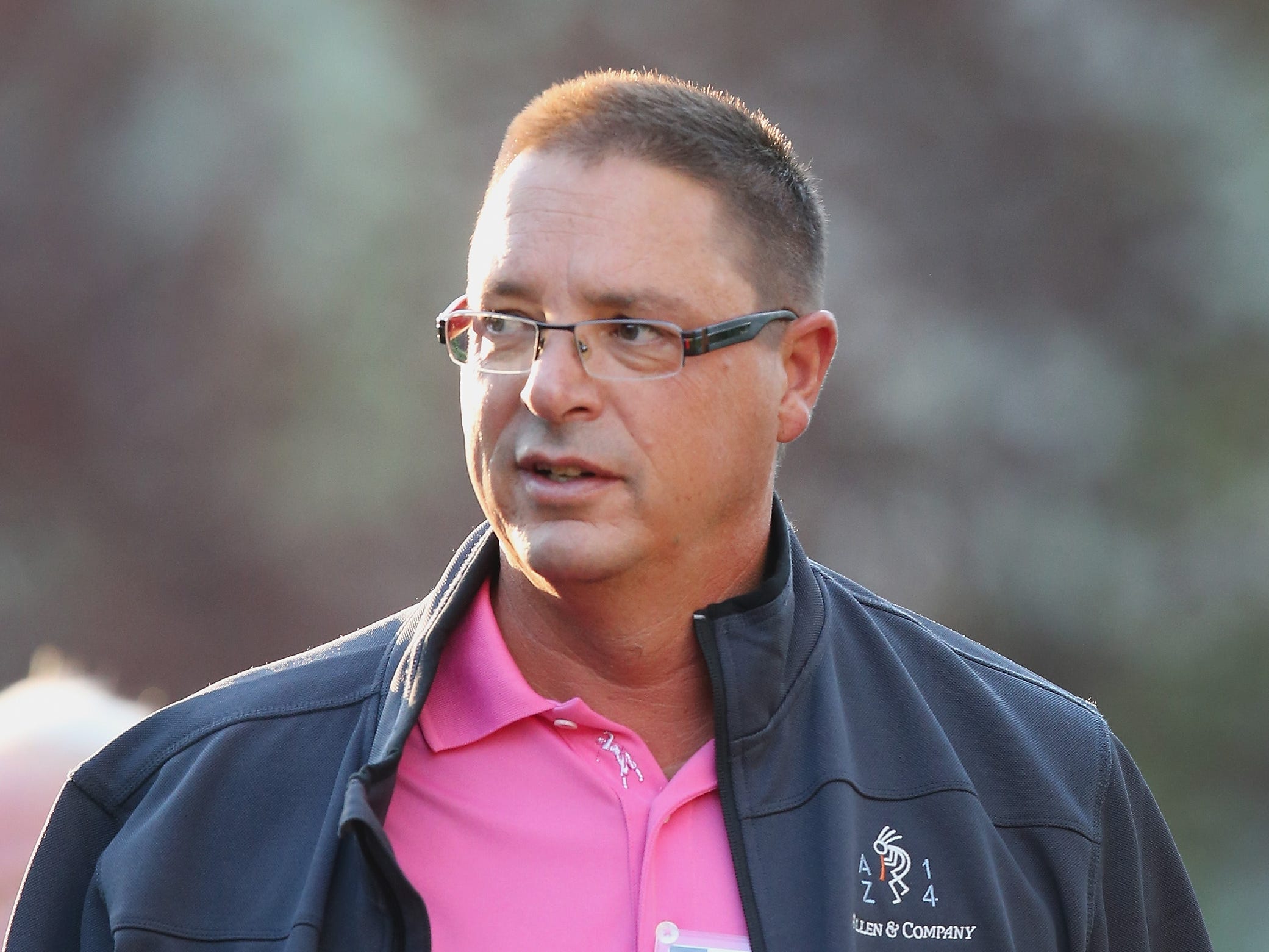 Michael Larson wearing a hot pink polo and a jacket