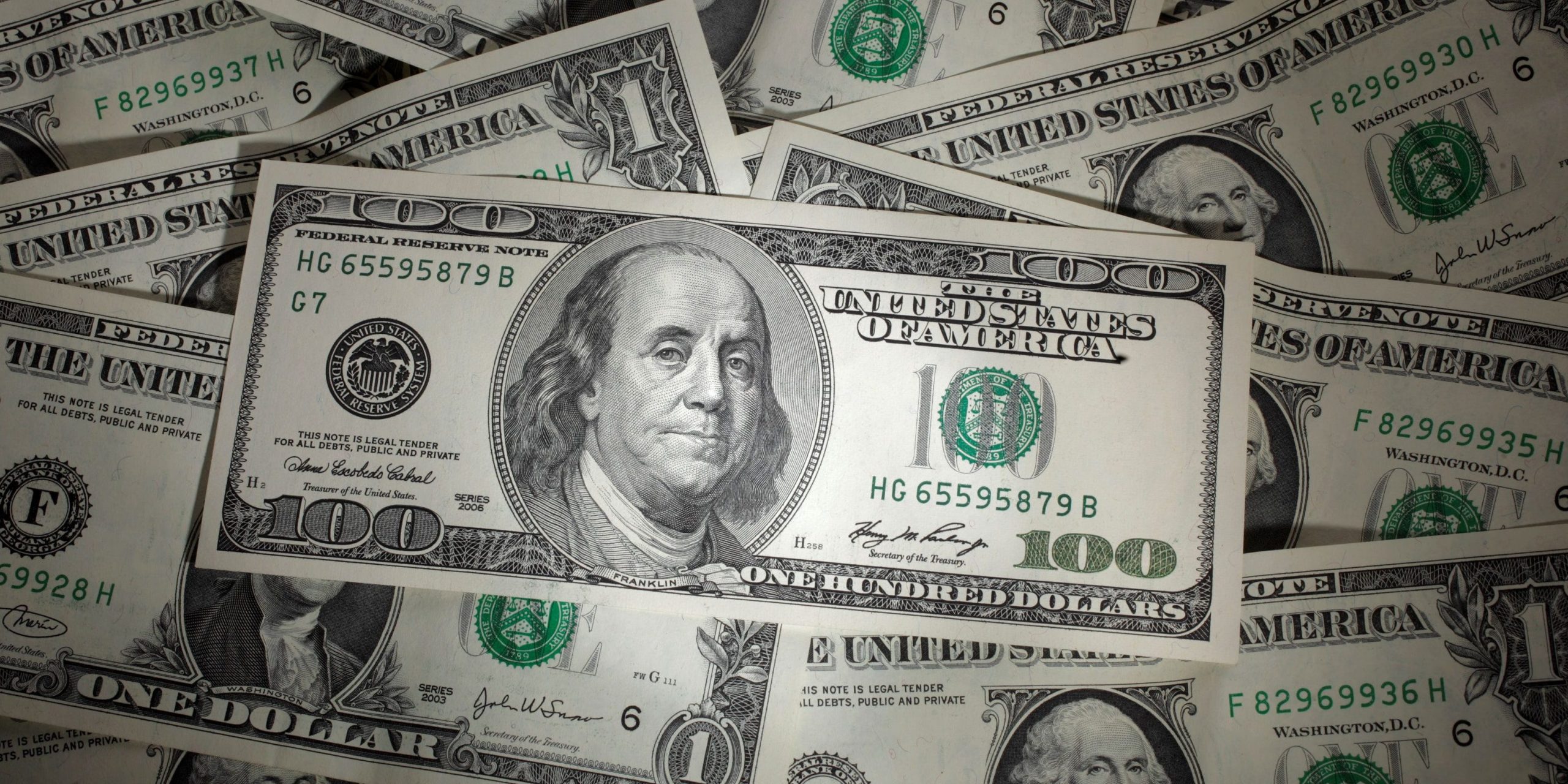 FILE PHOTO: A picture illustration shows a 100 Dollar banknote laying on one Dollar banknotes, taken in Warsaw, January 13, 2011. REUTERS/Kacper Pempel/File Photo
