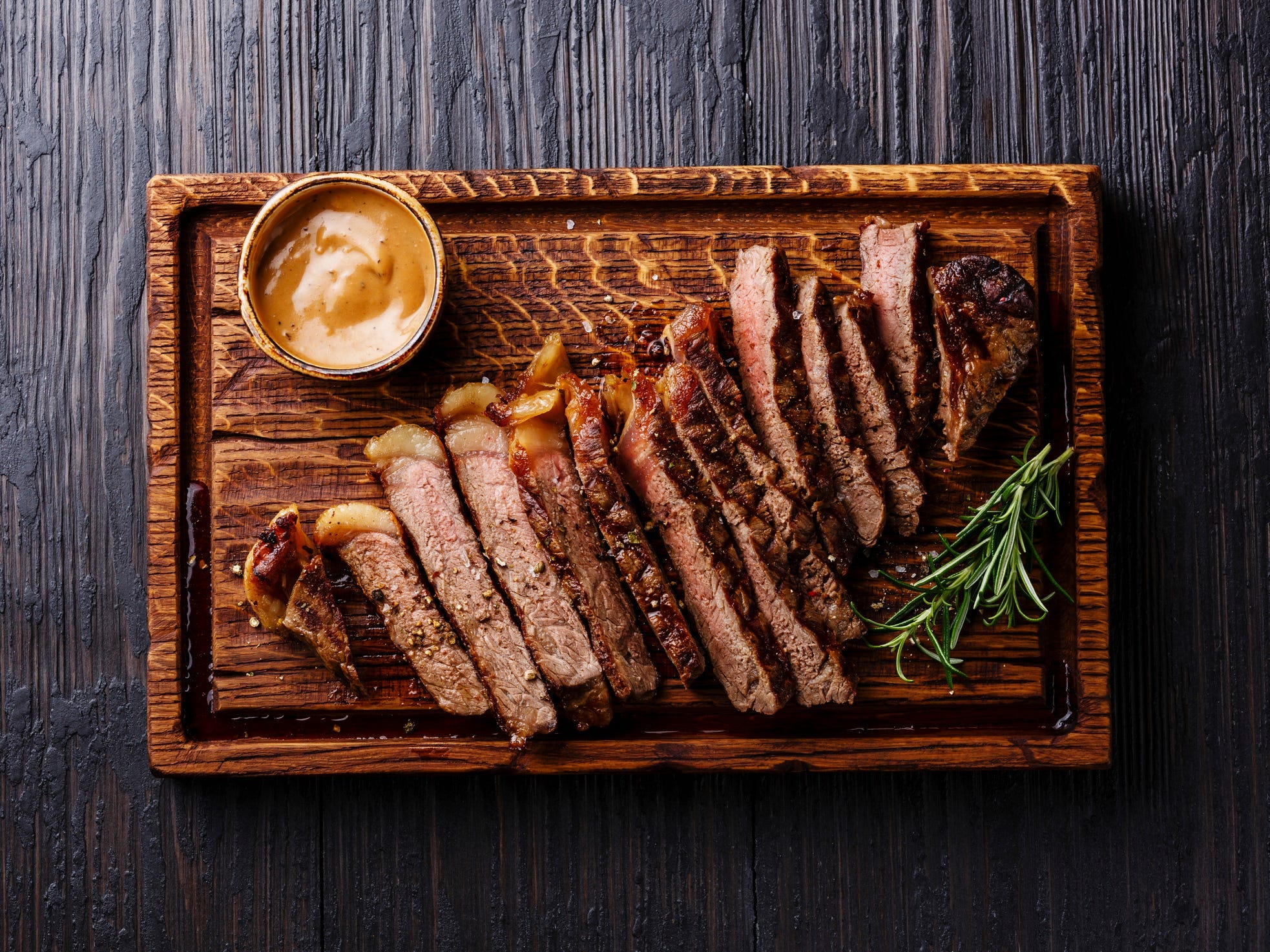 Well-done steak sliced on a cutting board