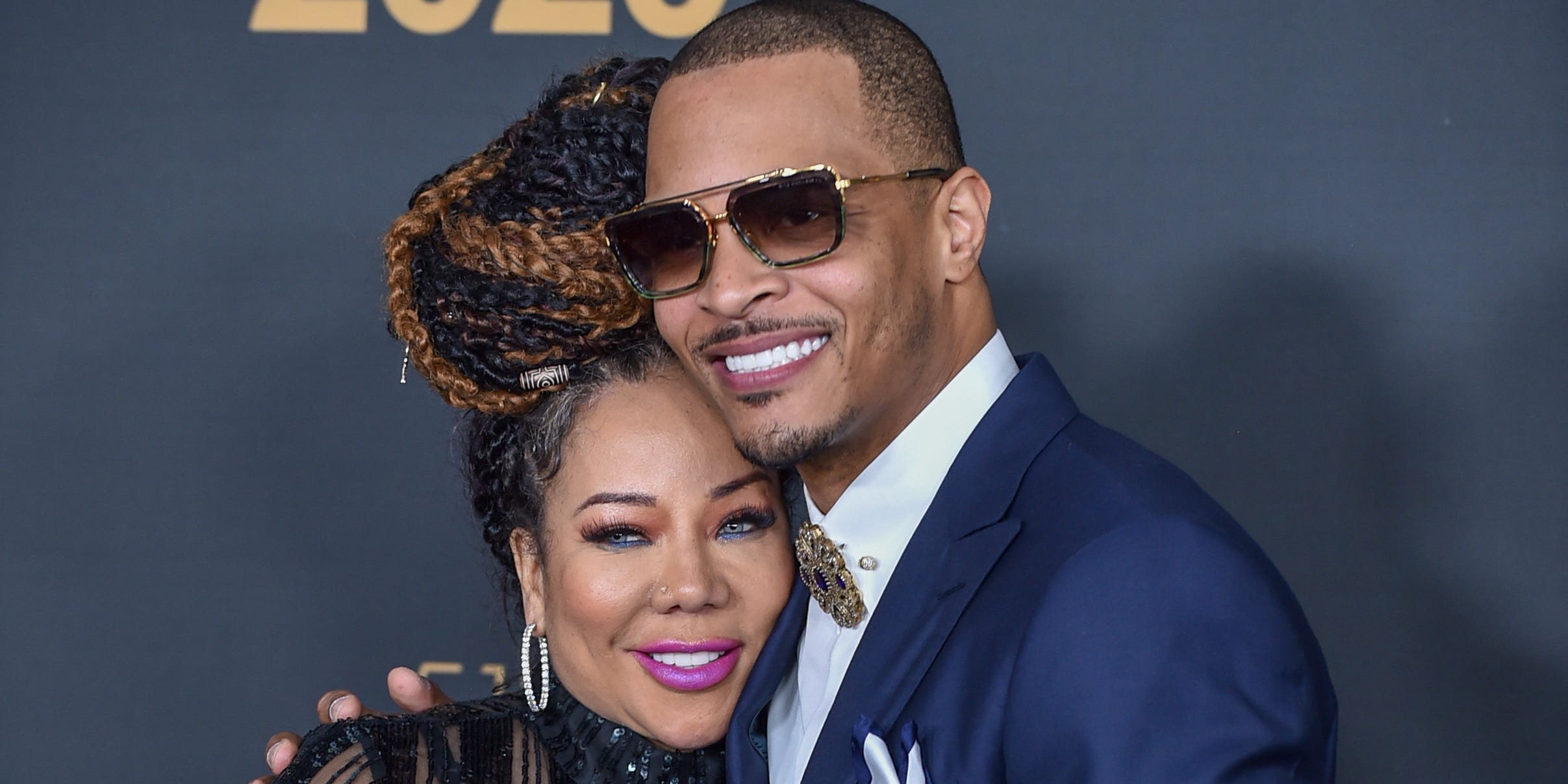 Rapper T.I. and his wife Tameka "Tiny" Harris on a red carpet