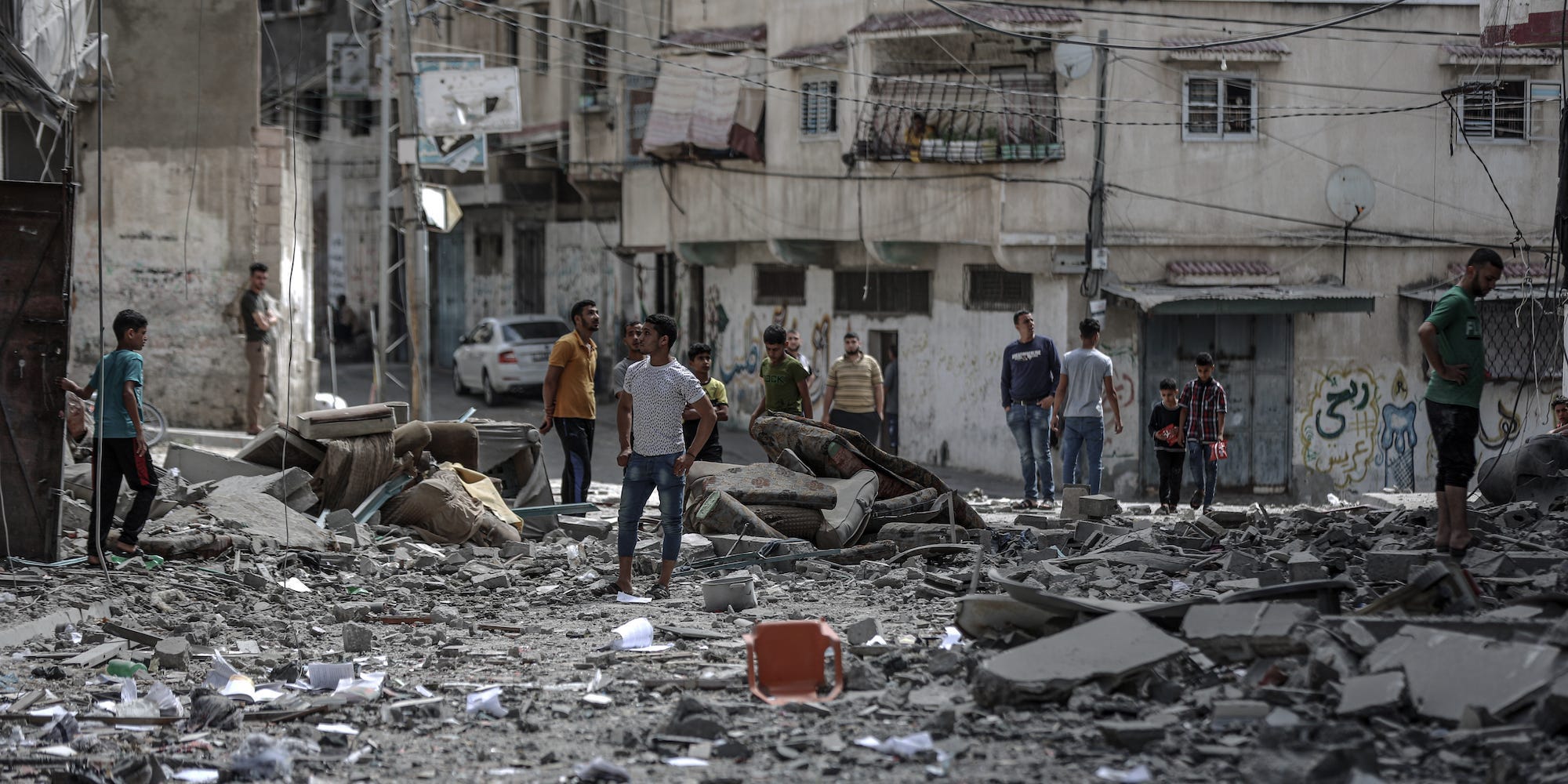 Palestinians inspect damaged building after airstrikes by Israeli army hit buildings in Gaza City, Gaza on May 17, 2021.