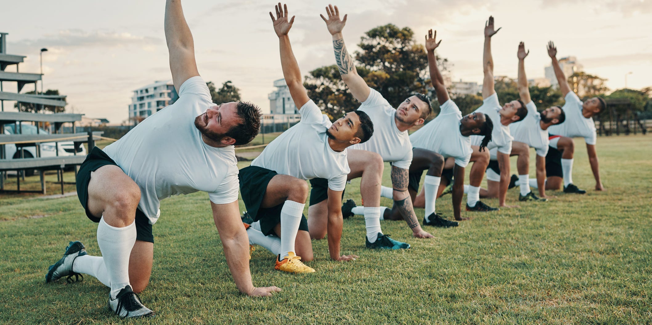 rugby platers doing a warm up routine with stretches before exercise