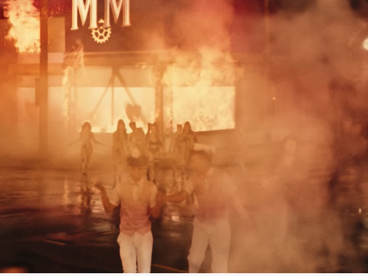build a bitch music video larray and james charles in front of flaming building