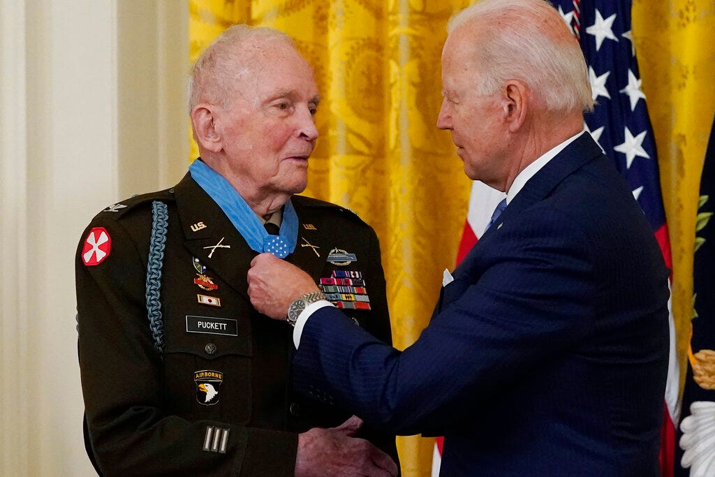 President Joe Biden speaks with retired U.S. Army Col. Ralph Puckett after he was presented the Medal of Honor, in the East Room of the White House, Friday, May 21, 2021, in Washington.