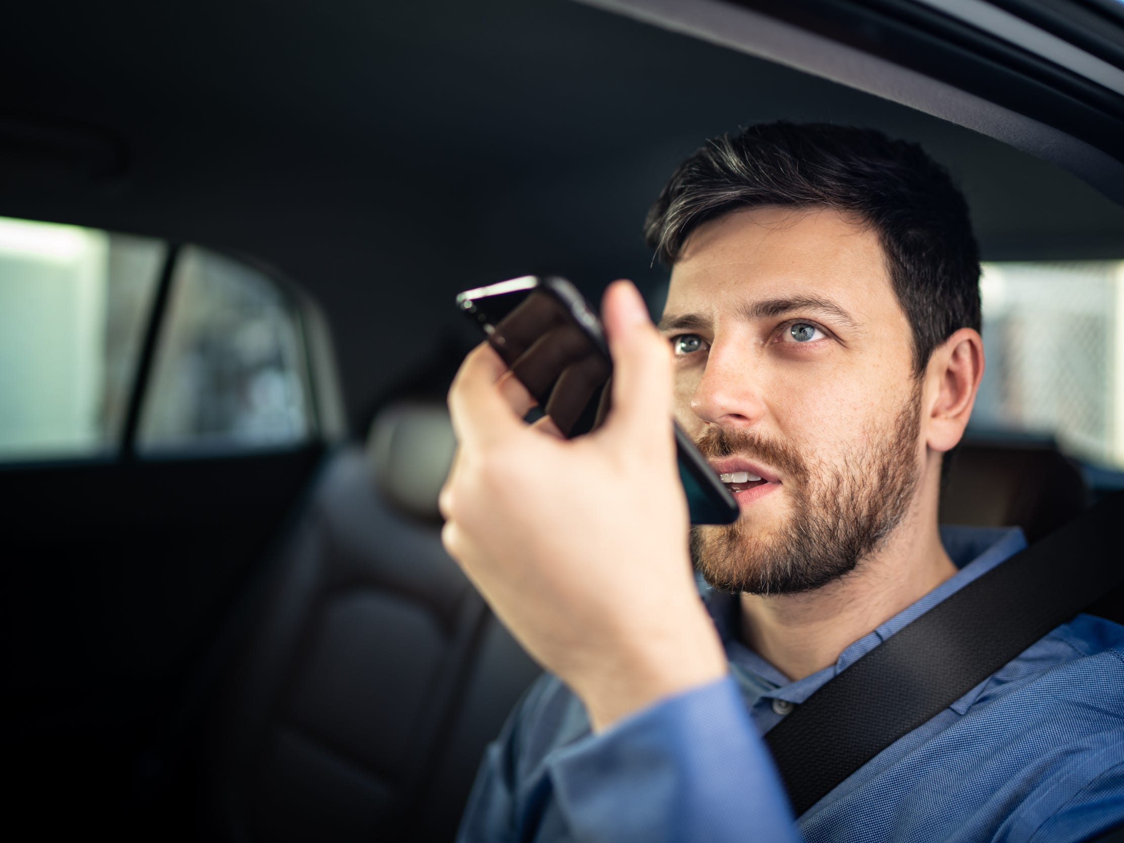 man in car talking on phone recording call