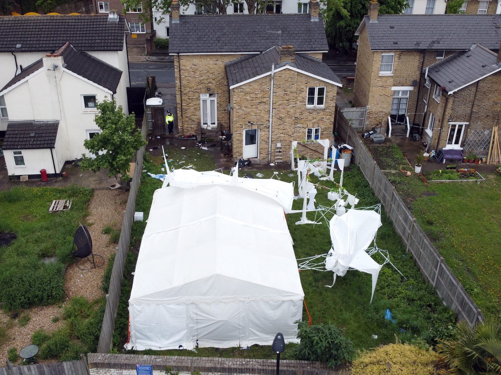 An overhead view of the back garden of the London house where Sasha Johnson was shot. The garden holds one large marquee and other party furniture.