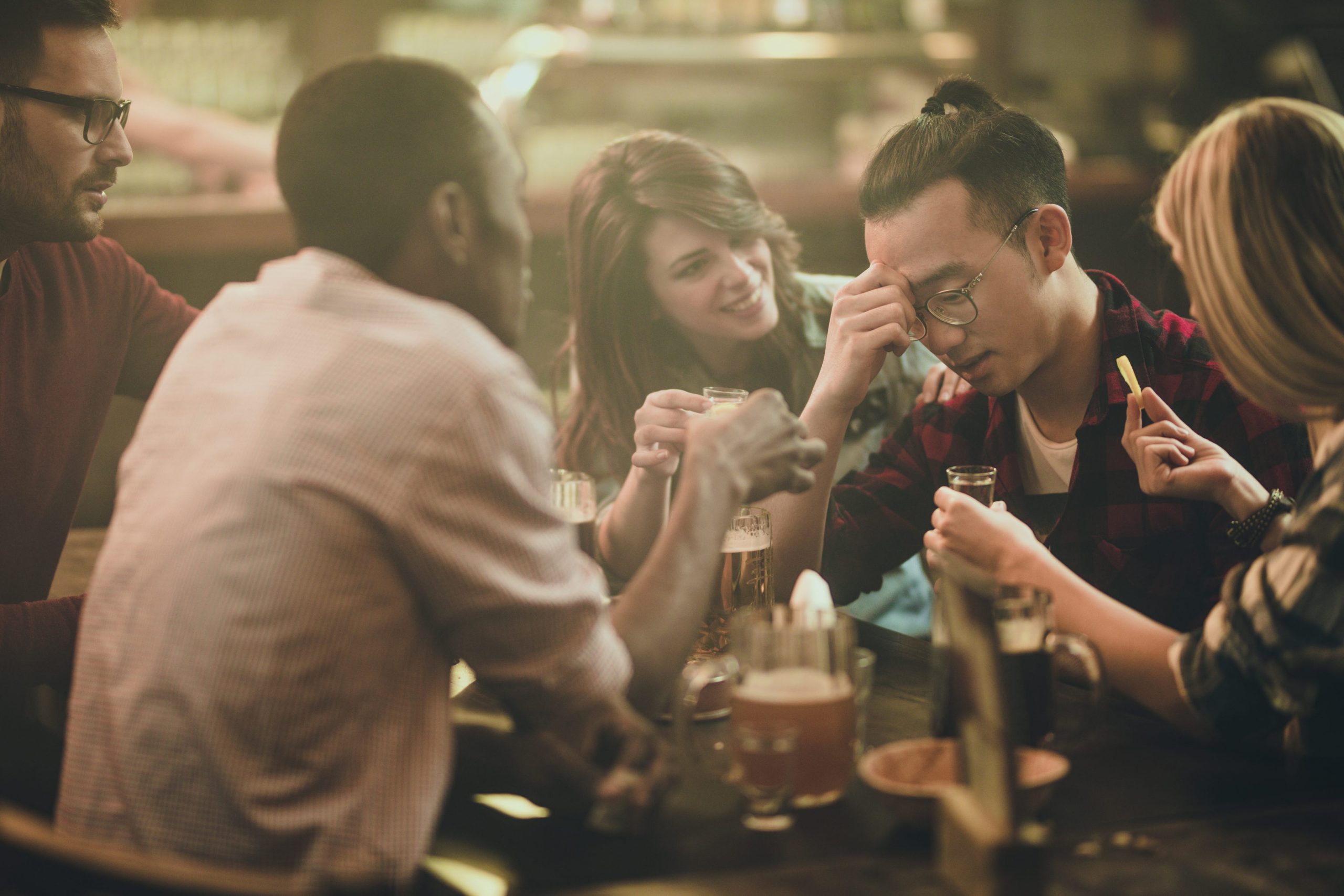 friends drinking alcohol in bar