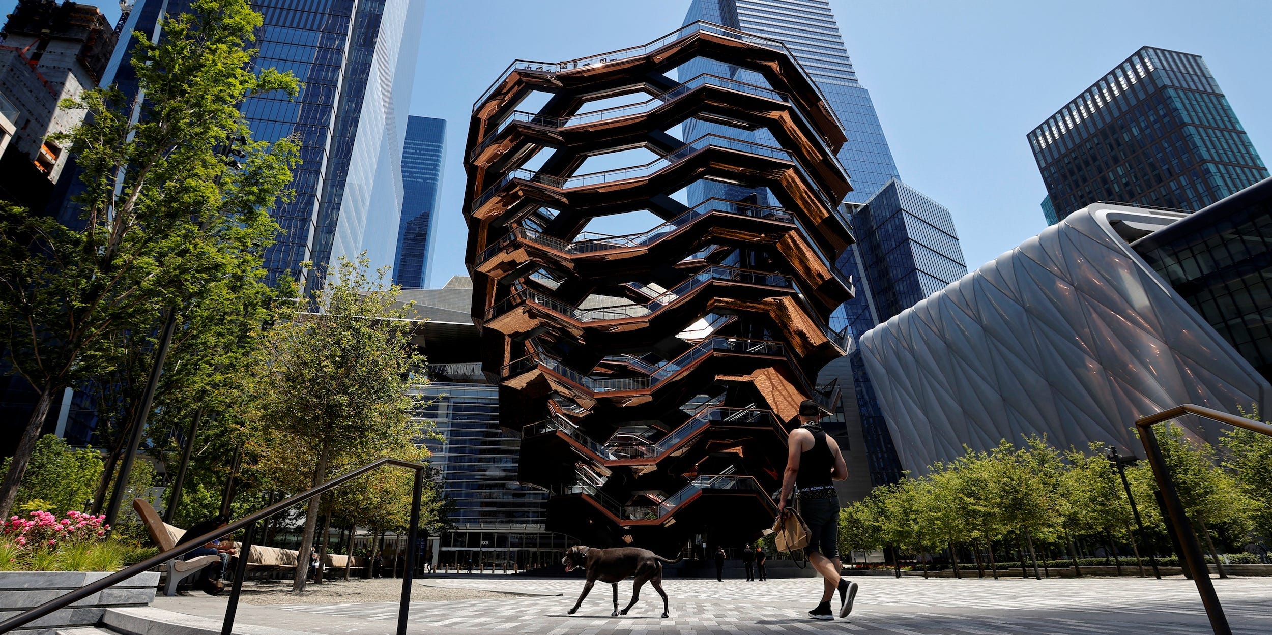 A man walks a dog past 'The Vessel' at Hudson Yards in Manhattan.JPG