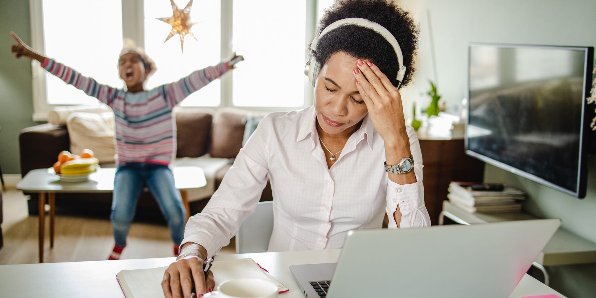 mother stressed at work while kid is screaming in background