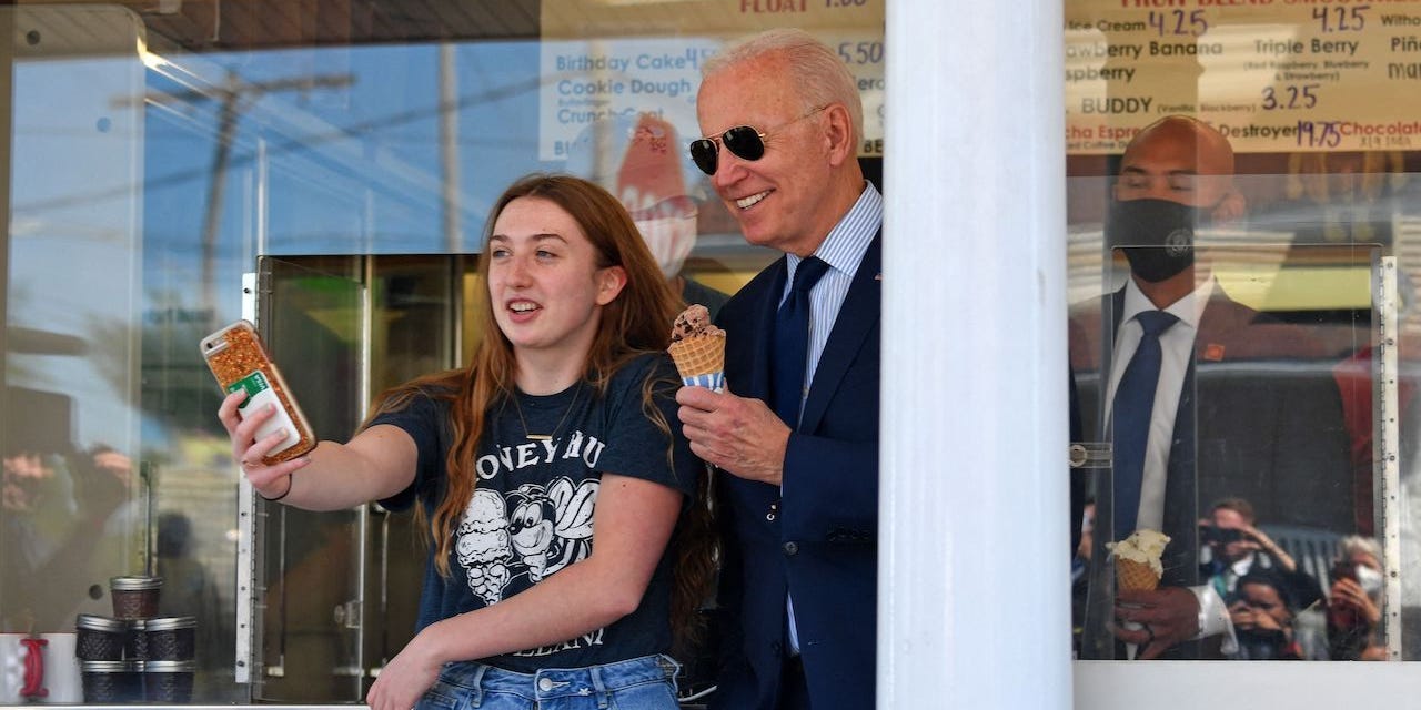 President Joe Biden poses for a photo with a girl after getting an ice cream at Honey Hut Ice Cream in Cleveland, Ohio, on May 27, 2021.