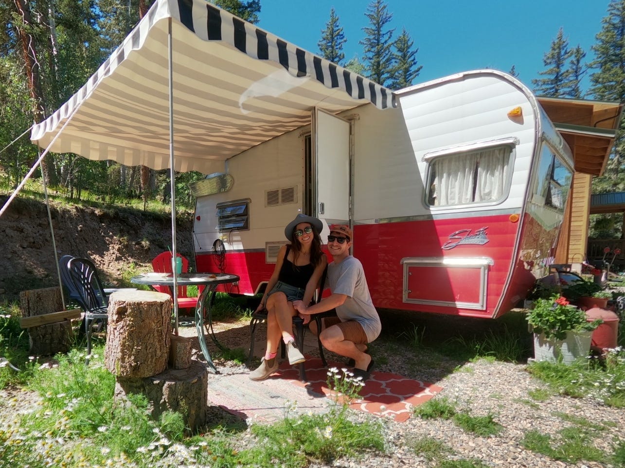 Dylan Barahona and his partner in front of their mobile home.