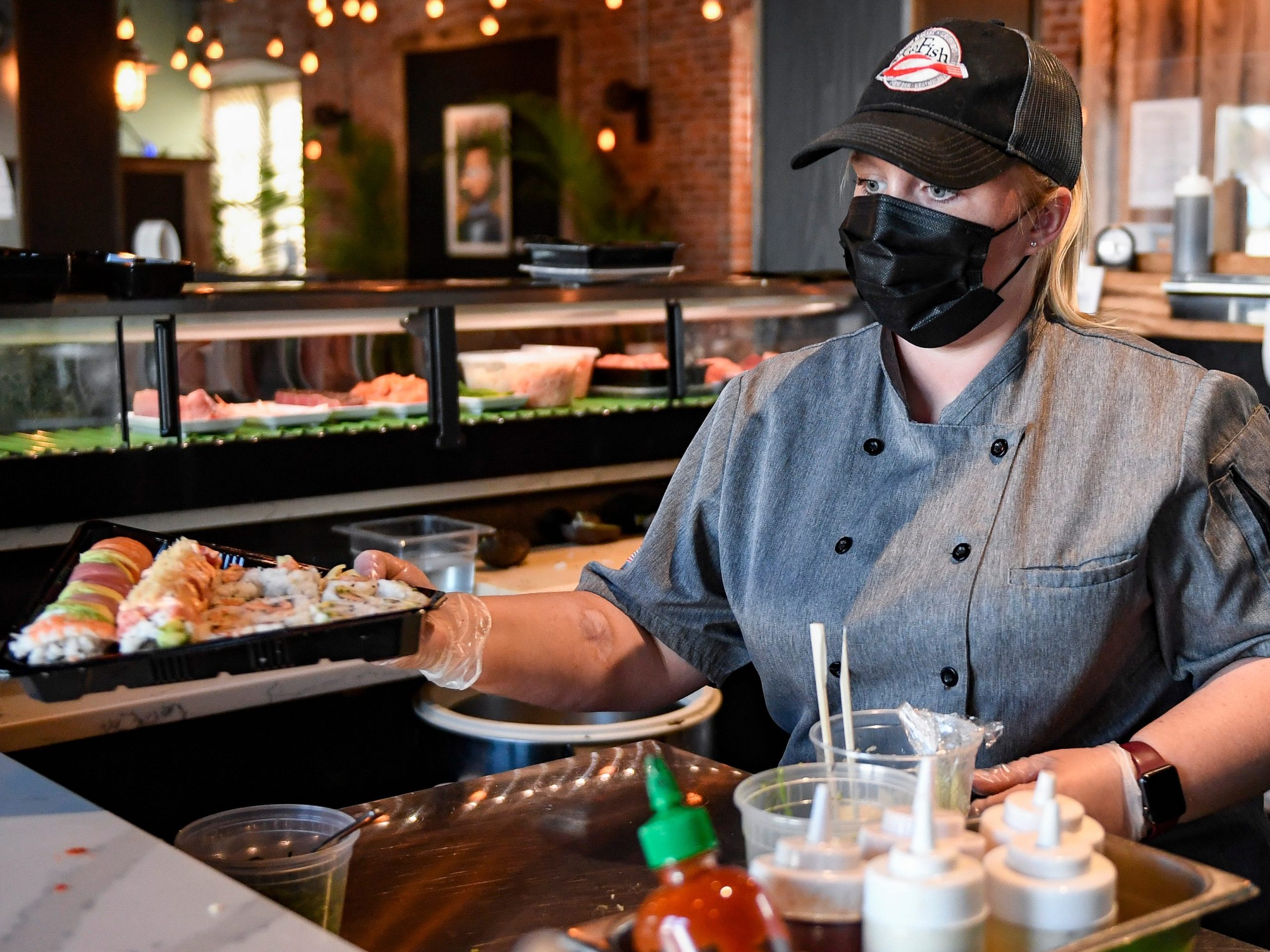 Sushi Chef Jessica Loness with an order of sushi she just finished preparing at the Go Fish! Seafood Restaurant and Sushi Bar in Sinking Spring in April 2021.