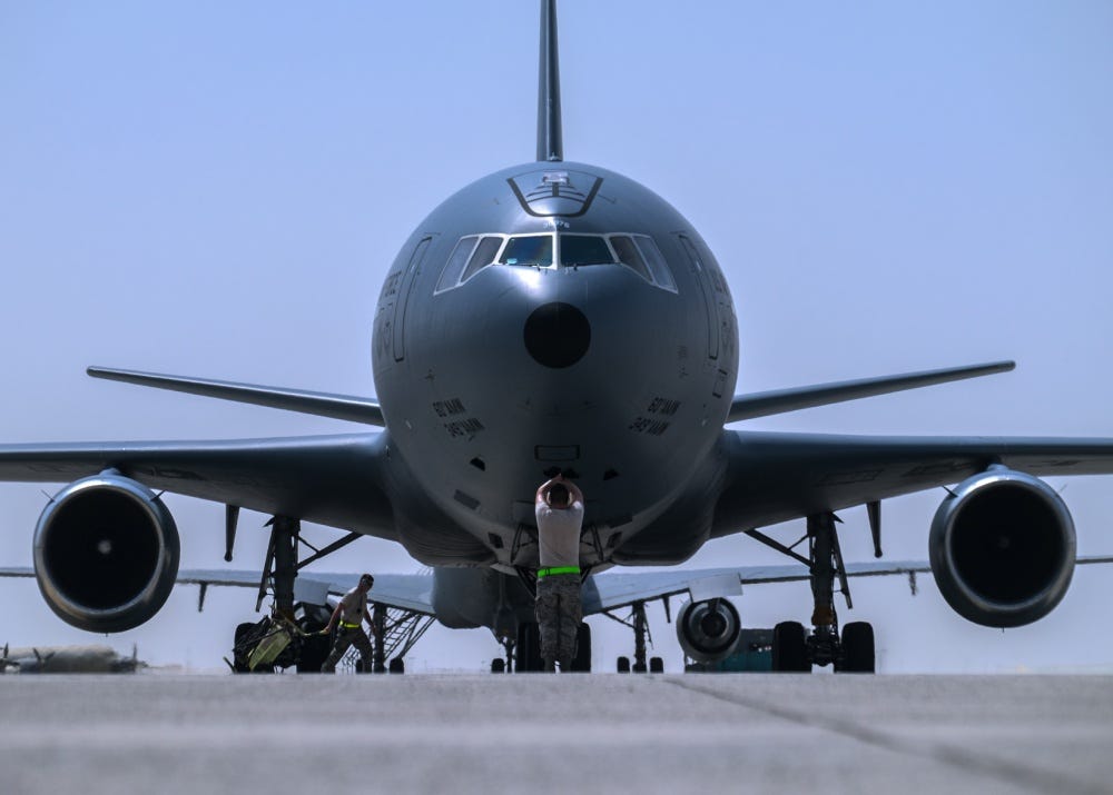 Tech. Sgt. Javier, 380th Aircraft Maintenance Squadron Extender Aircraft Maintenance Unit crew chief, marshals a KC-10 Extender