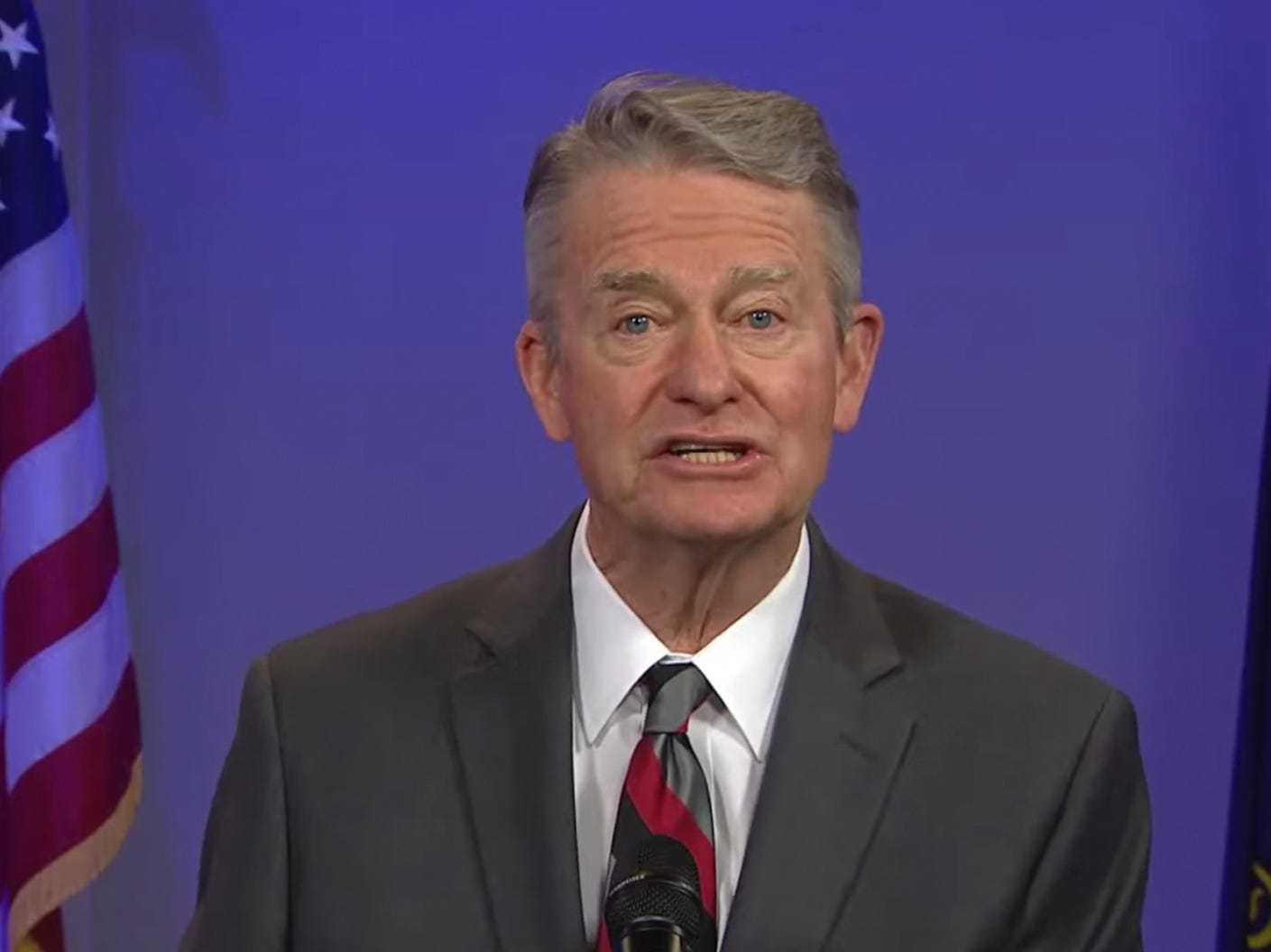 Idaho Gov. Brad Little in a suit and tie speaks to the camera