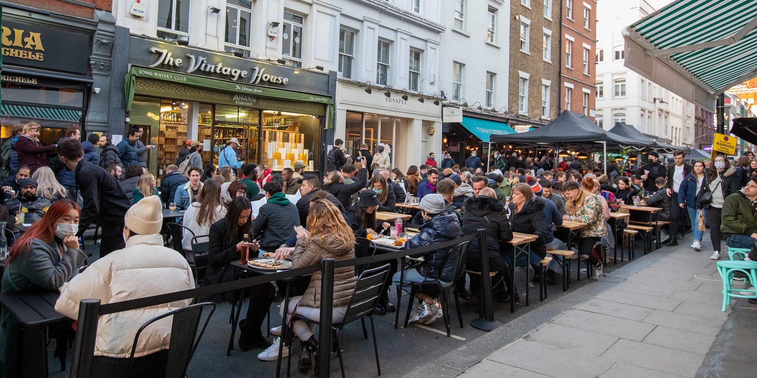 Crowds of people flock the outdoor restaurants and pub tables in Soho on April 12, 2021 in London, England