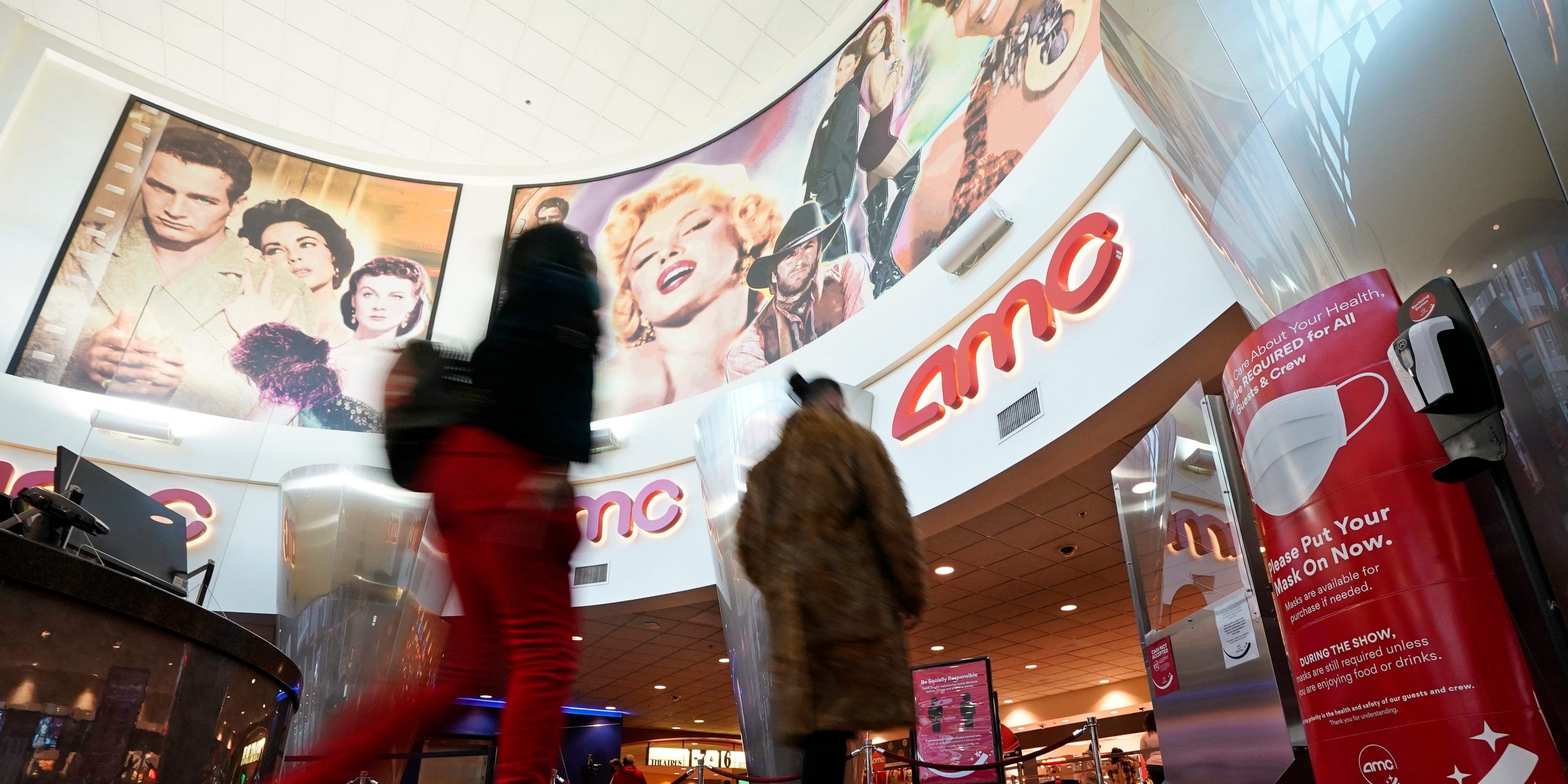 Movie patrons arrive to see a film at the AMC 16 theater in Burbank, California.