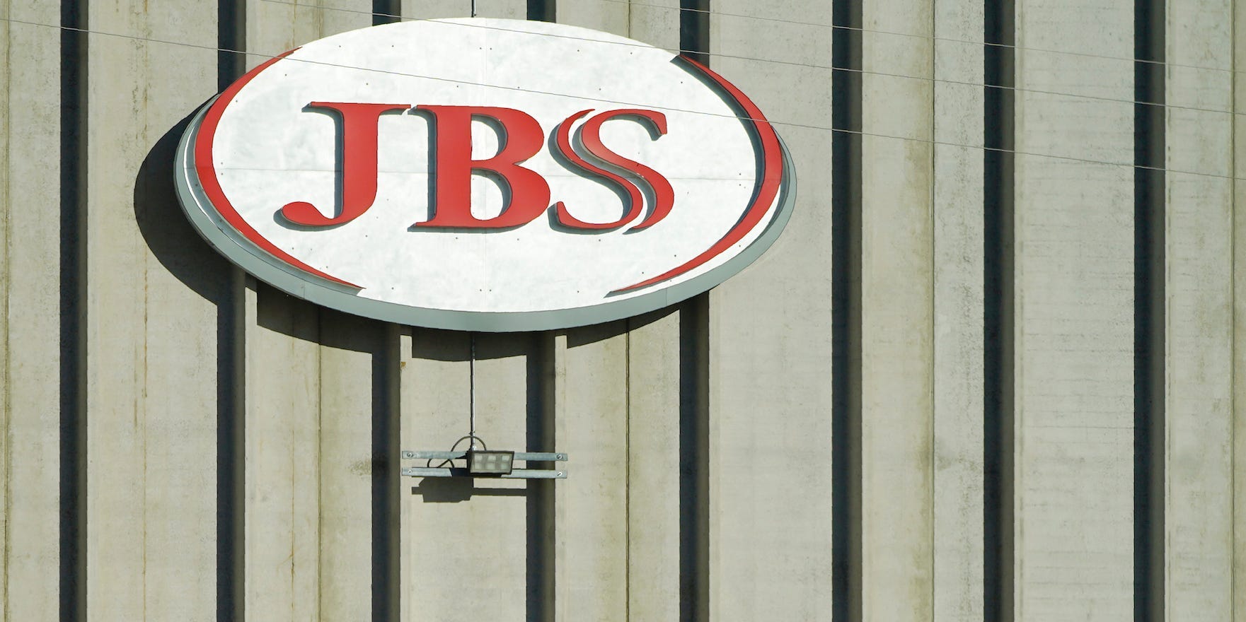 In this Oct. 12, 2020 file photo, a worker heads into the JBS meatpacking plant in Greeley, Colo