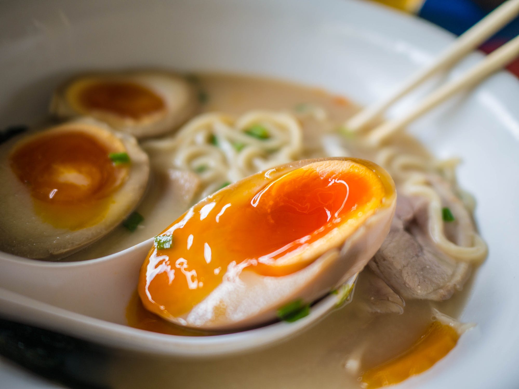 A soft boiled egg in a bowl of ramen