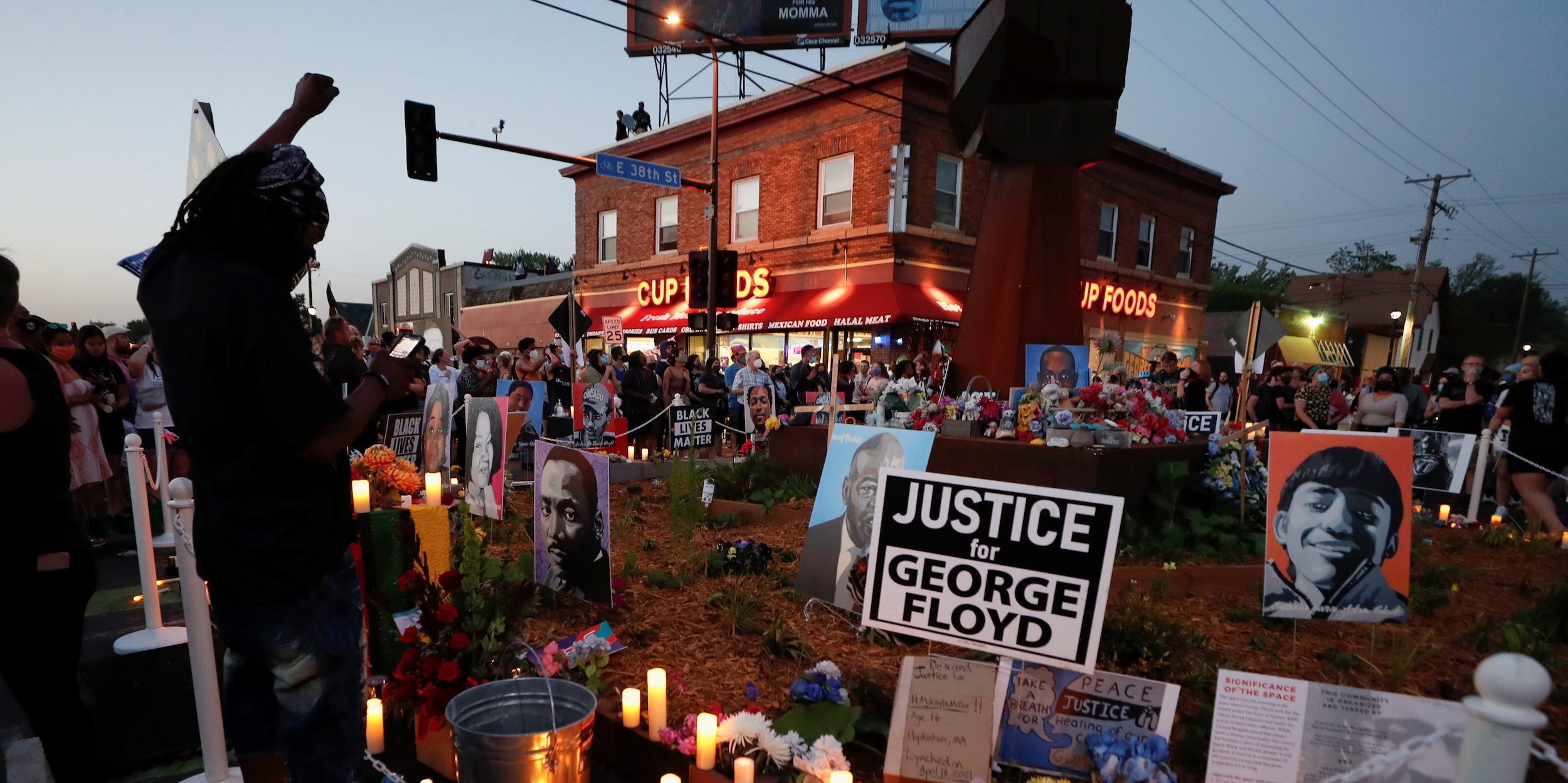 A person raises his fist at a memorial during a Celebration of Life festival in honor of George Floyd, who was killed by Minneapolis police one year ago, at George Floyd Square in south Minneapolis, Minnesota, U.S.