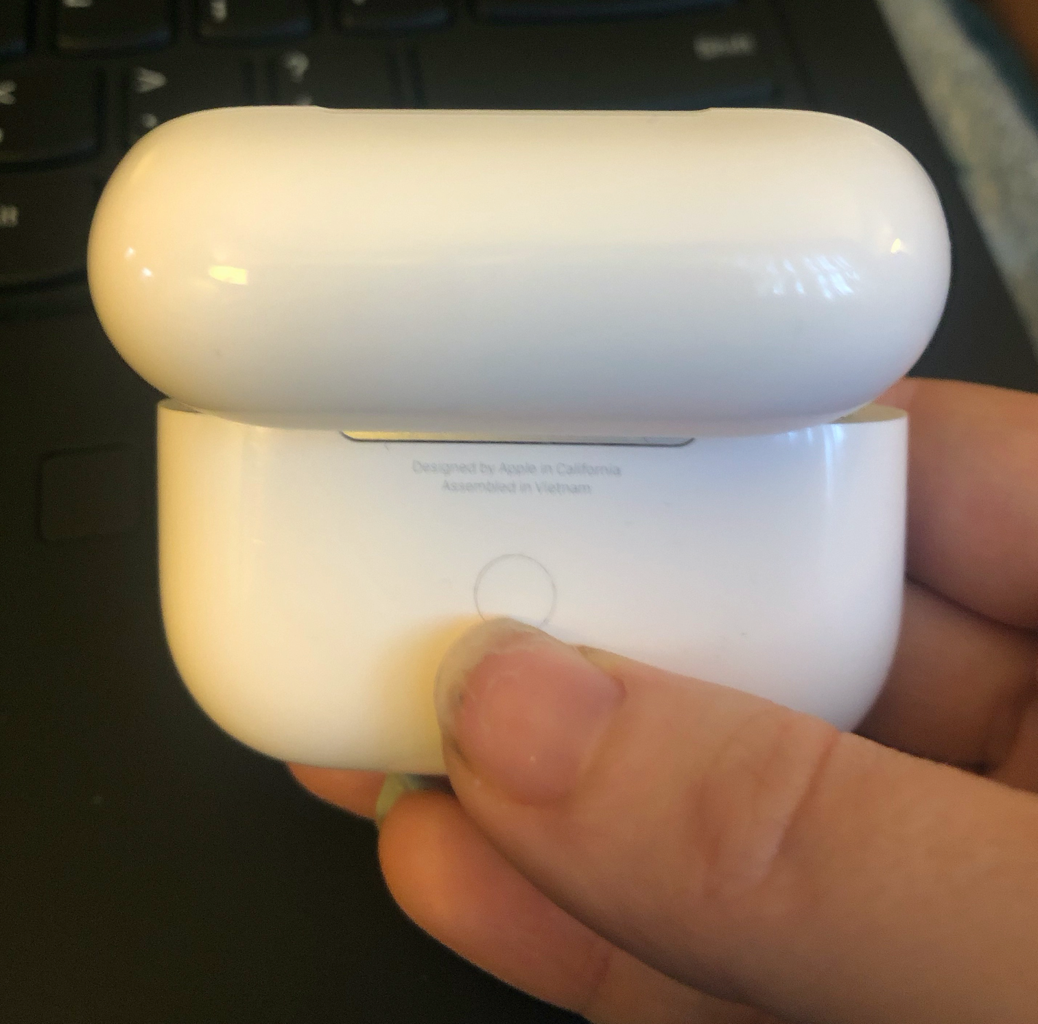 AirPods case, setup button on back