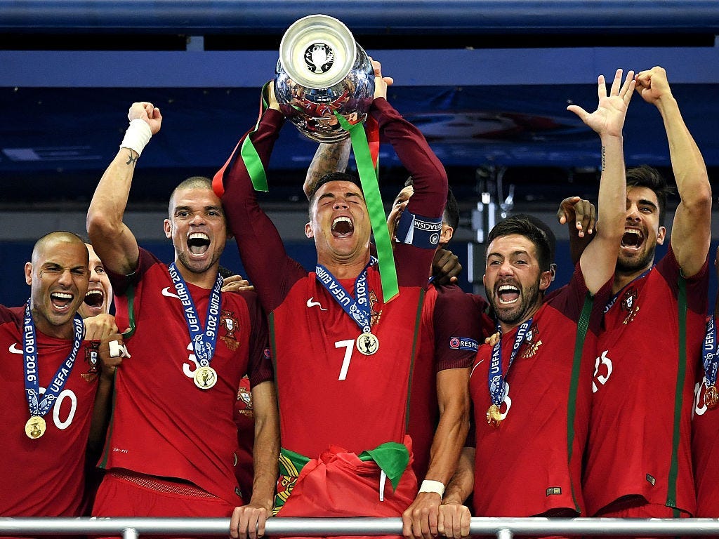 Cristiano Ronaldo of Portugal (c) lifts the Henri Delaunay trophy after his side win 1-0 against France during the UEFA EURO 2016 Final match between Portugal and France