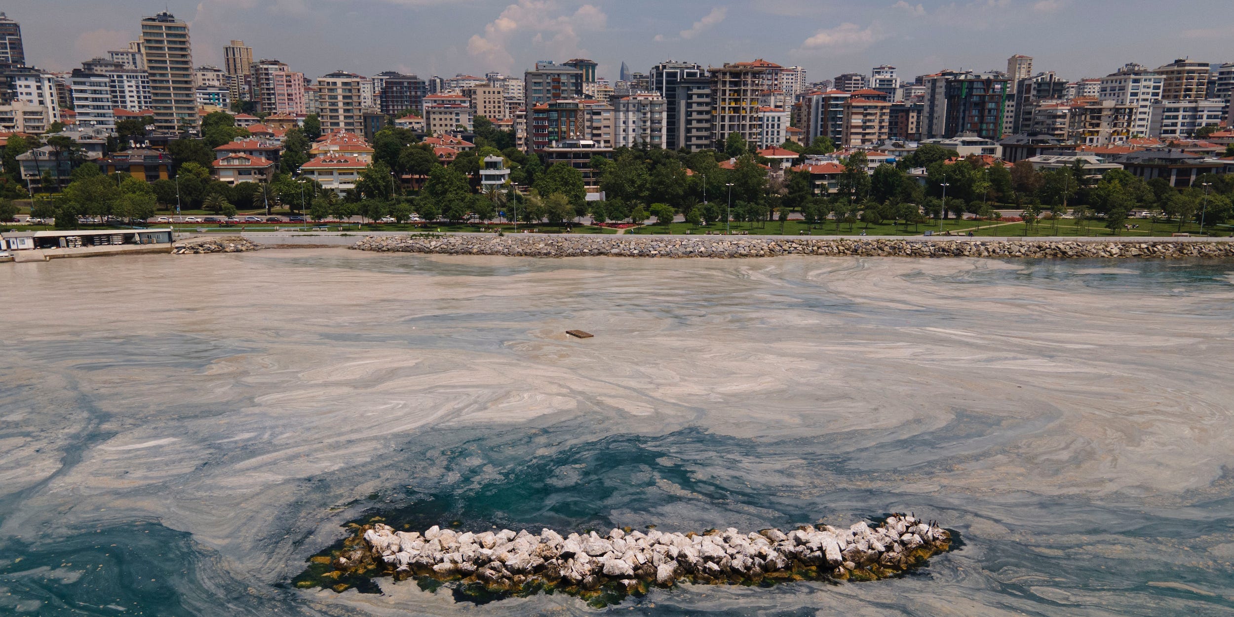 An aerial photo of the sea at the Caddebostan shore, in Asian side of Istanbul, Monday, June 7, 2021, with a huge mass of marine mucilage, a thick, slimy substance made up of compounds released by marine organisms, in Turkey's Marmara Sea.