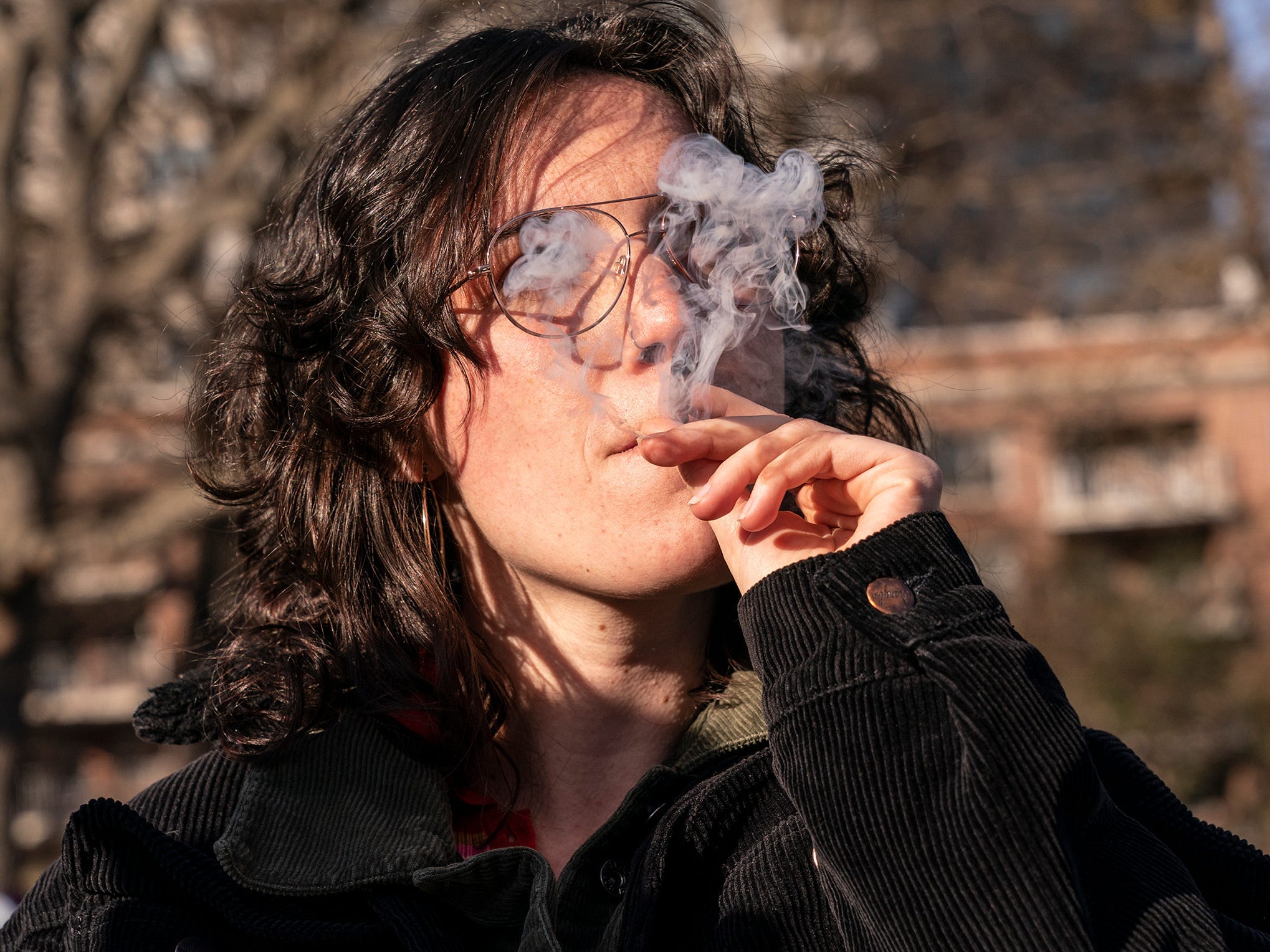 Person smoking cannabis joint New York