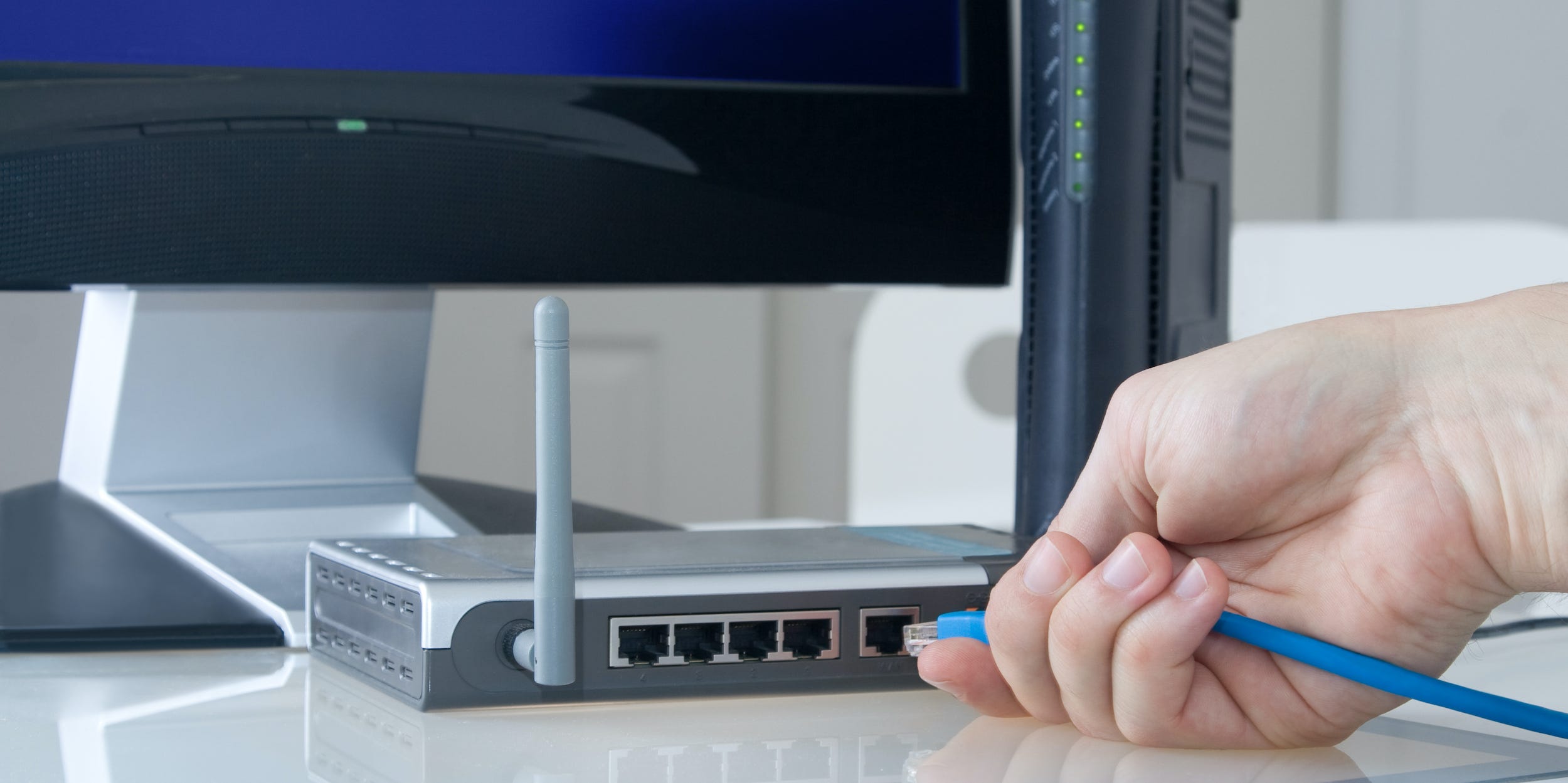 internet router being hooked up to desktop computer