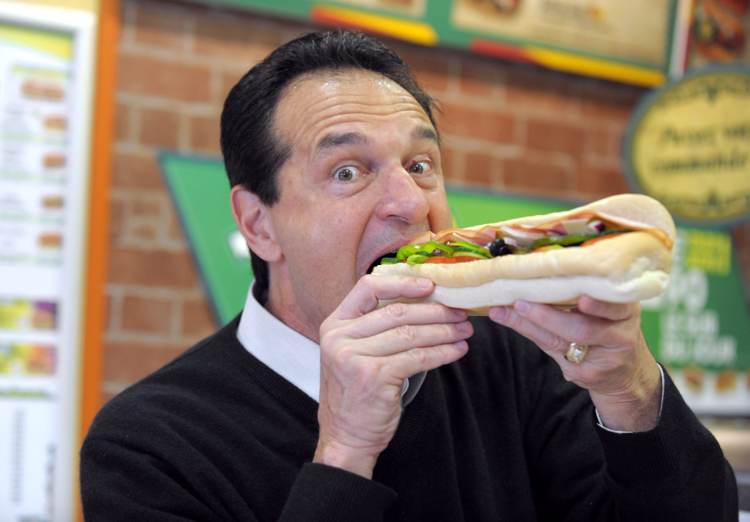 _Fred DeLuca, poses with a sandwich in a Parisian Subway restaurant on June 17, 2011 Photo credit should read ERIC PIERMONT_AFP via Getty Images