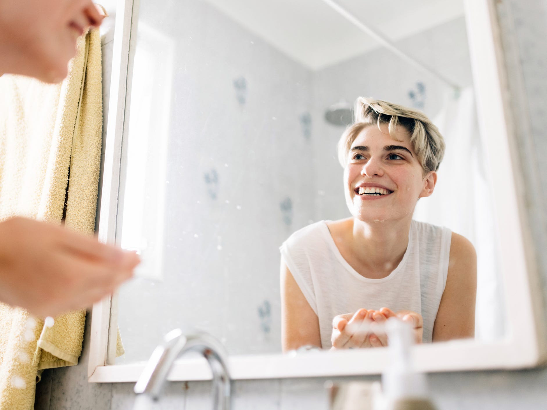 Trans person washing face