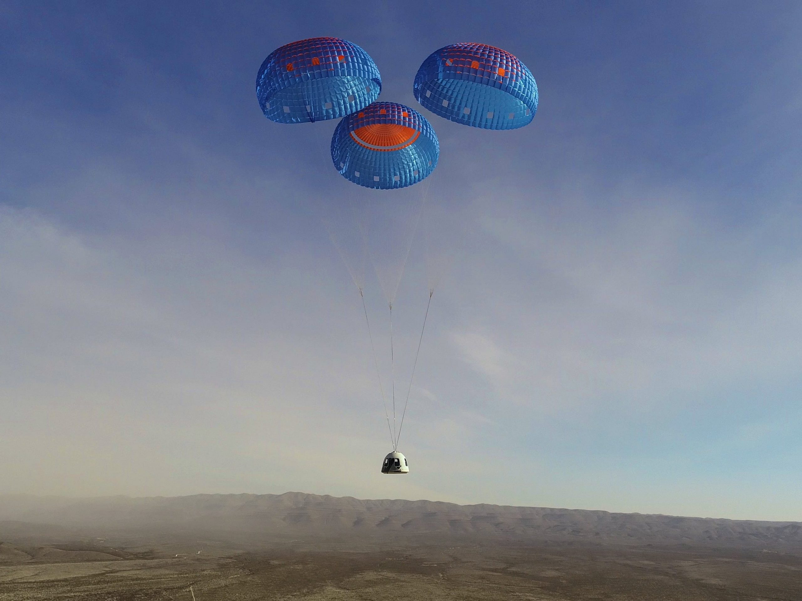 The New Shepard crew capsule parachutes to a landing at Blue Origin's Launch Site One in Texas on January 14.