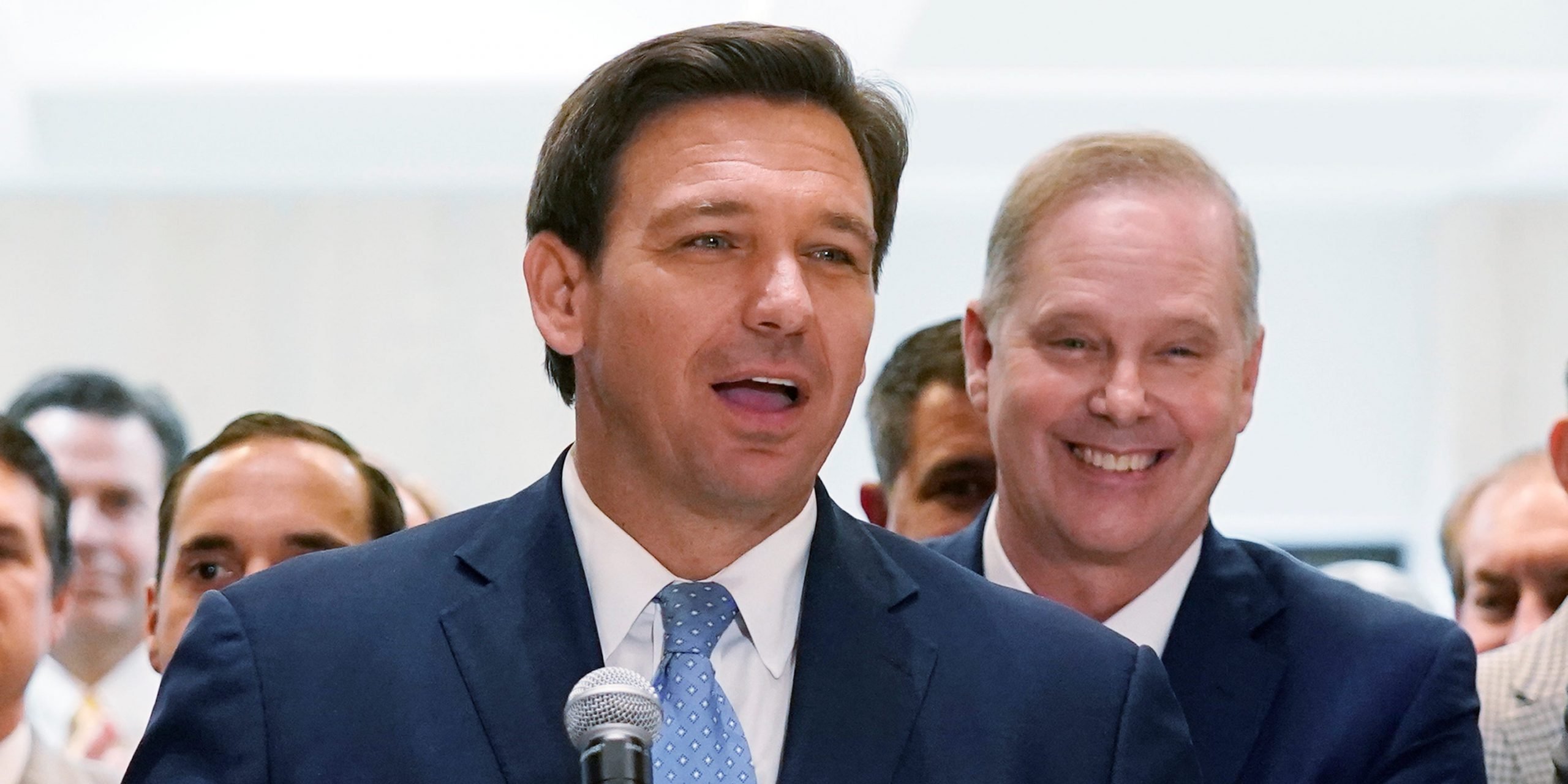 Gov. Ron DeSantis surrounded by lawmakers at the Tallahassee Capitol.