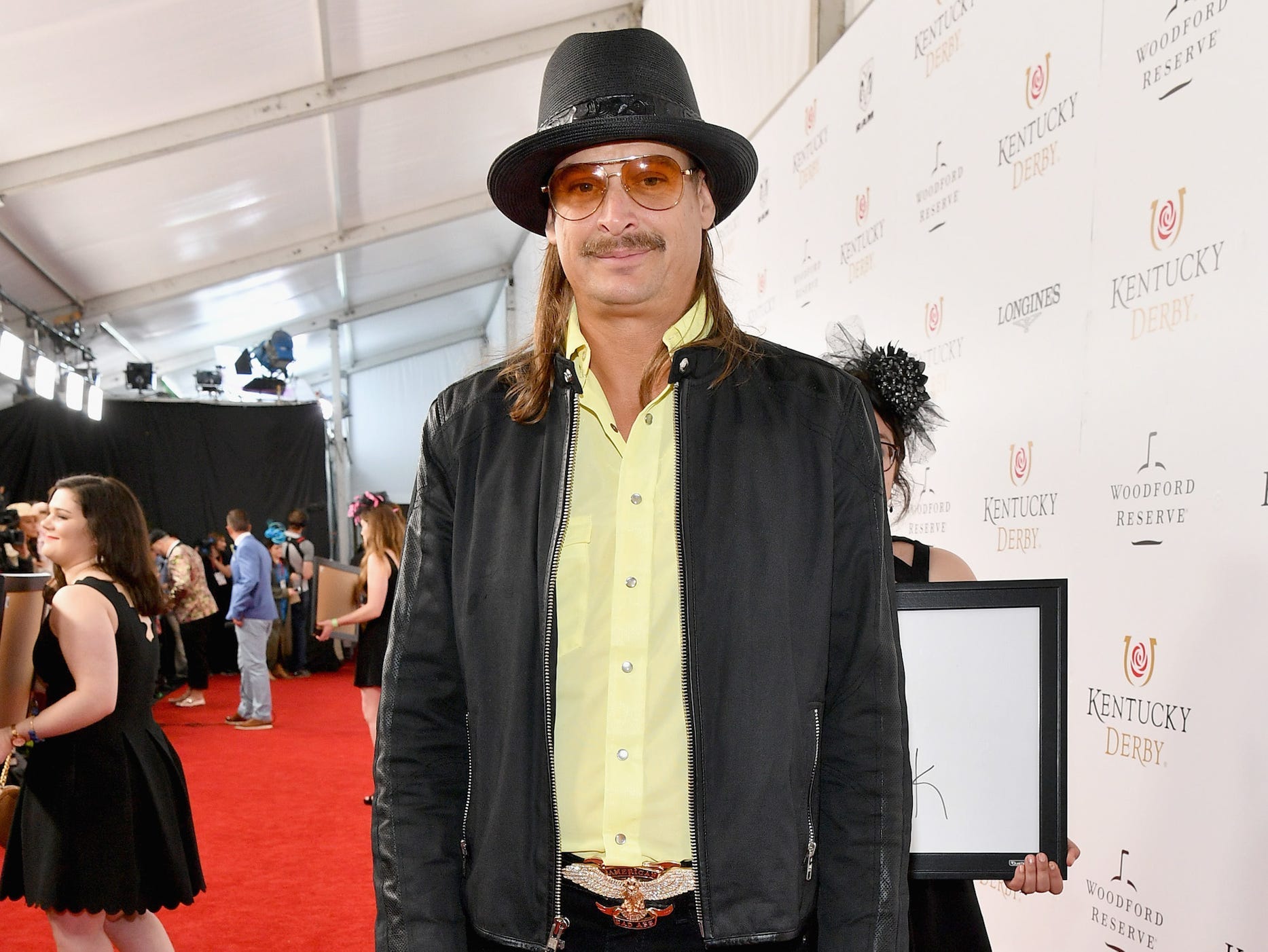 kid rock standing on a red carpet
