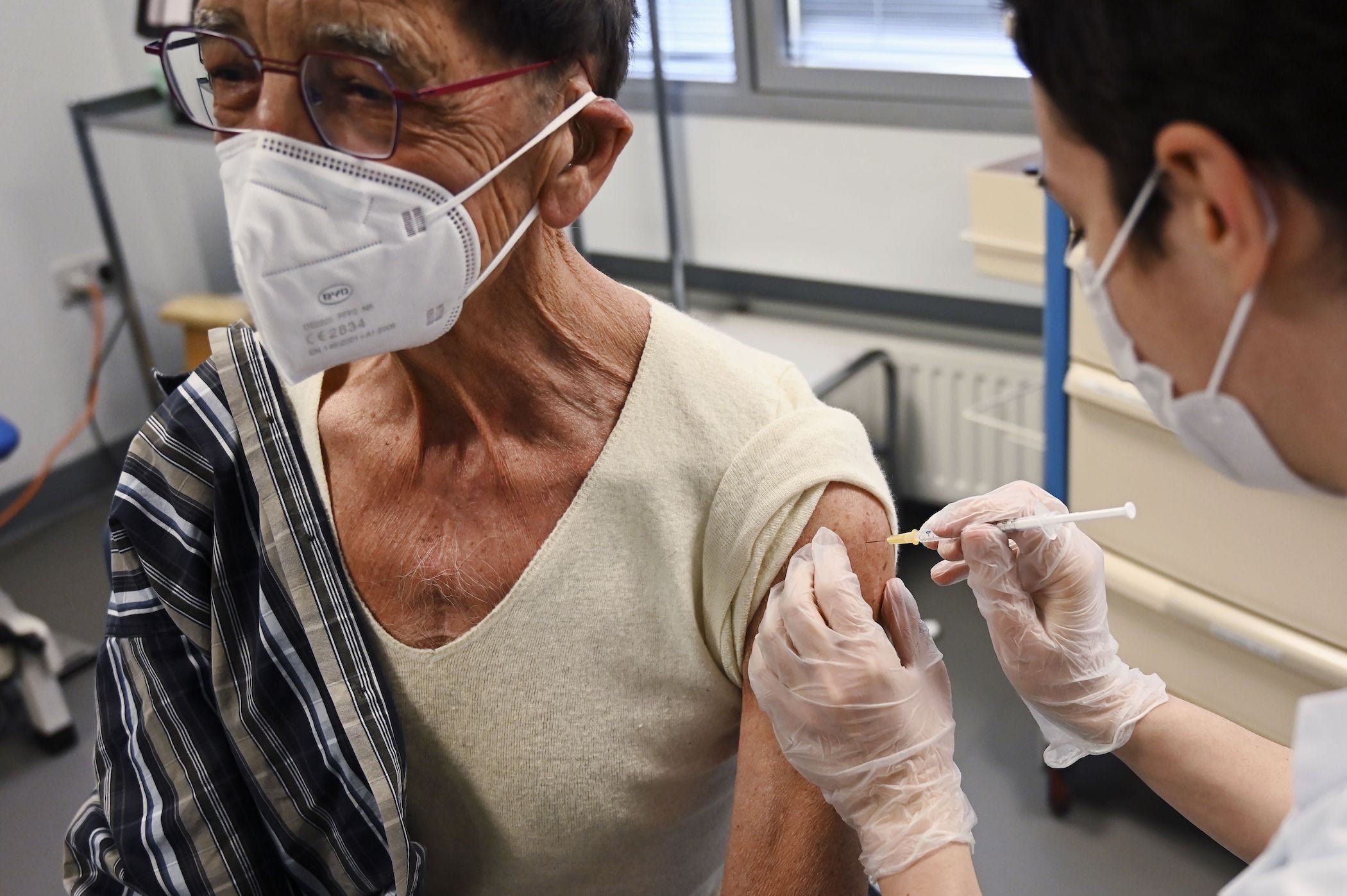 a man with a heart transplant seen getting a COVID-19 shot