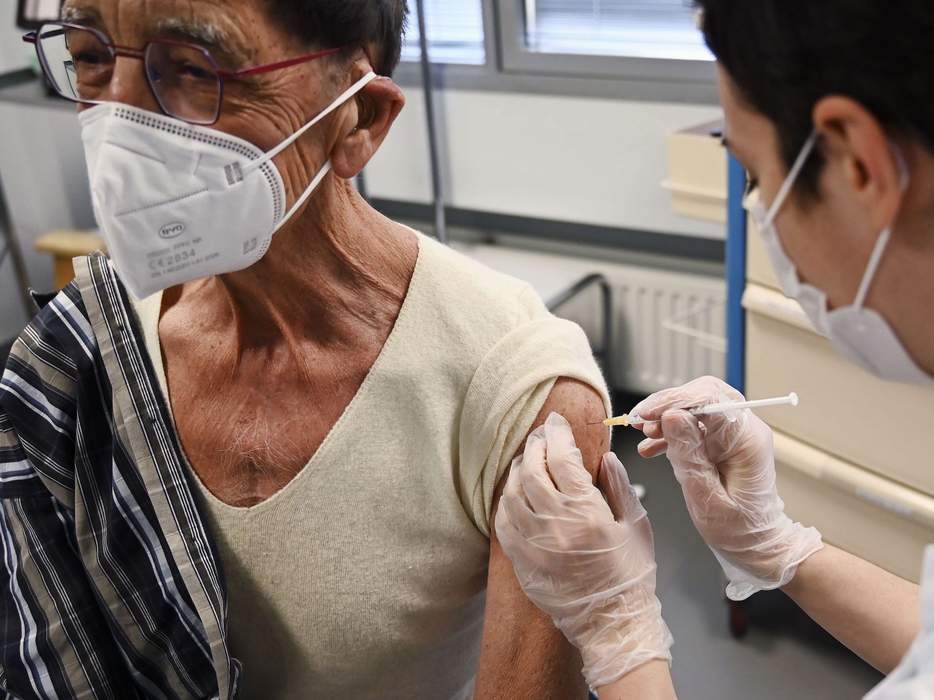 a man with a heart transplant seen getting a COVID-19 shot