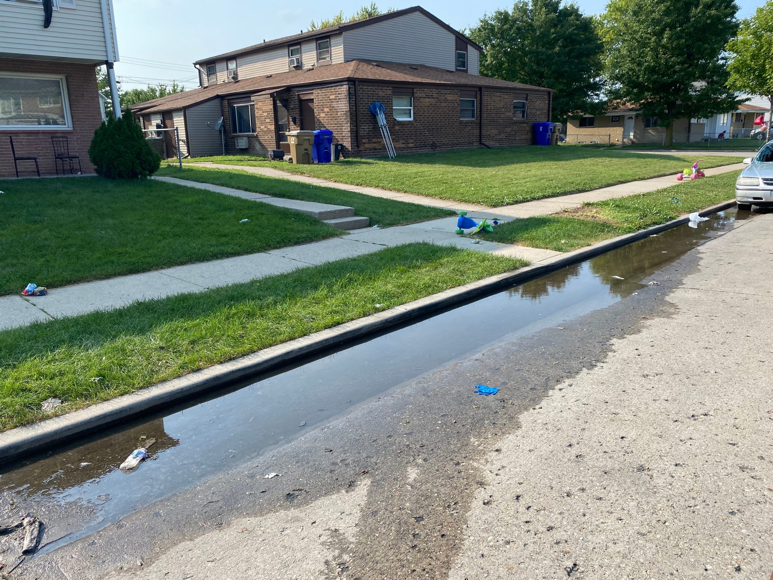 the scene where jacob blake was shot two days later has some water on the street and a discarded toy bike in front of it