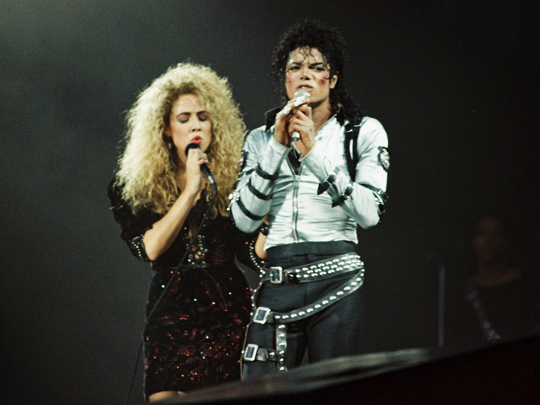 Sheryl Crow joins Michael Jackson to perform on stage on his BAD tour at Wembley Stadium.