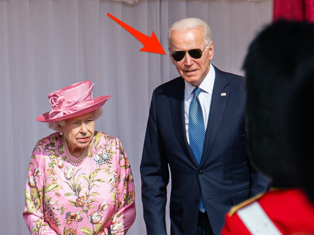 Jill Biden, Queen Elizabeth II, and Joe Biden stand on a stage together on June 13, 2021.