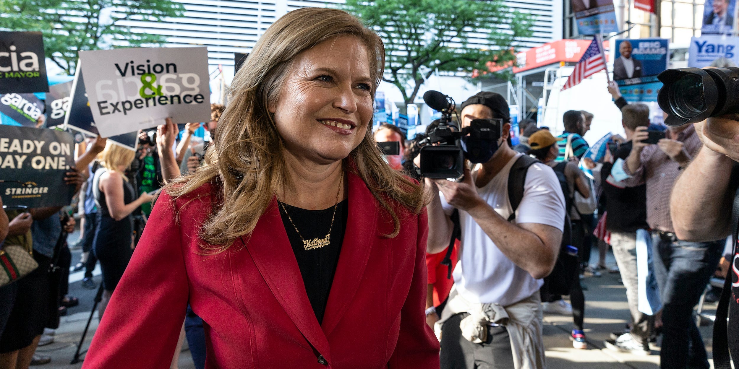 Democratic New York City mayoral candidate Kathryn Garcia enters a debate, backed by supporters.