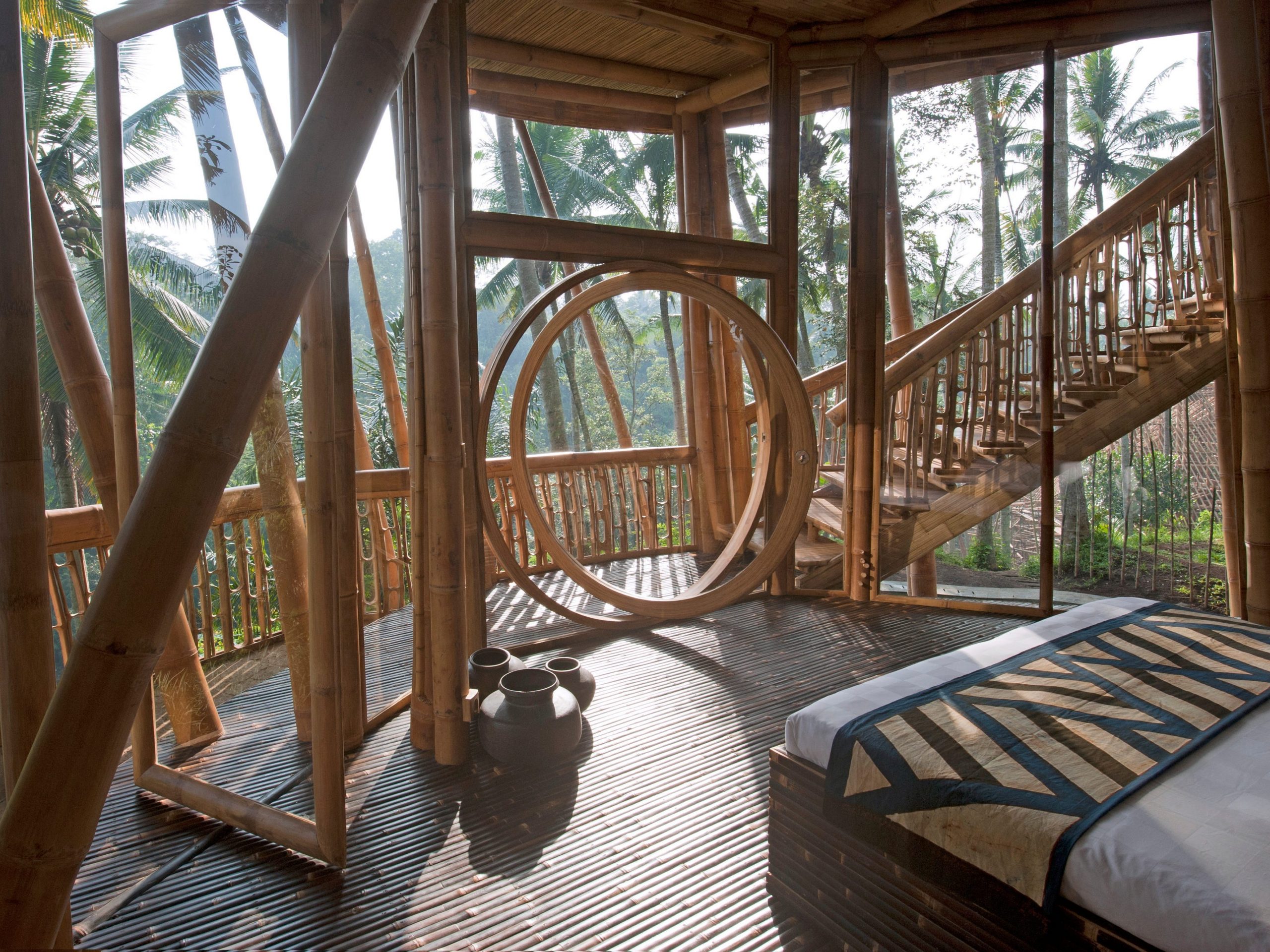 An Ibuku bedroom opens up to the natural air and has various intricate bamboo details